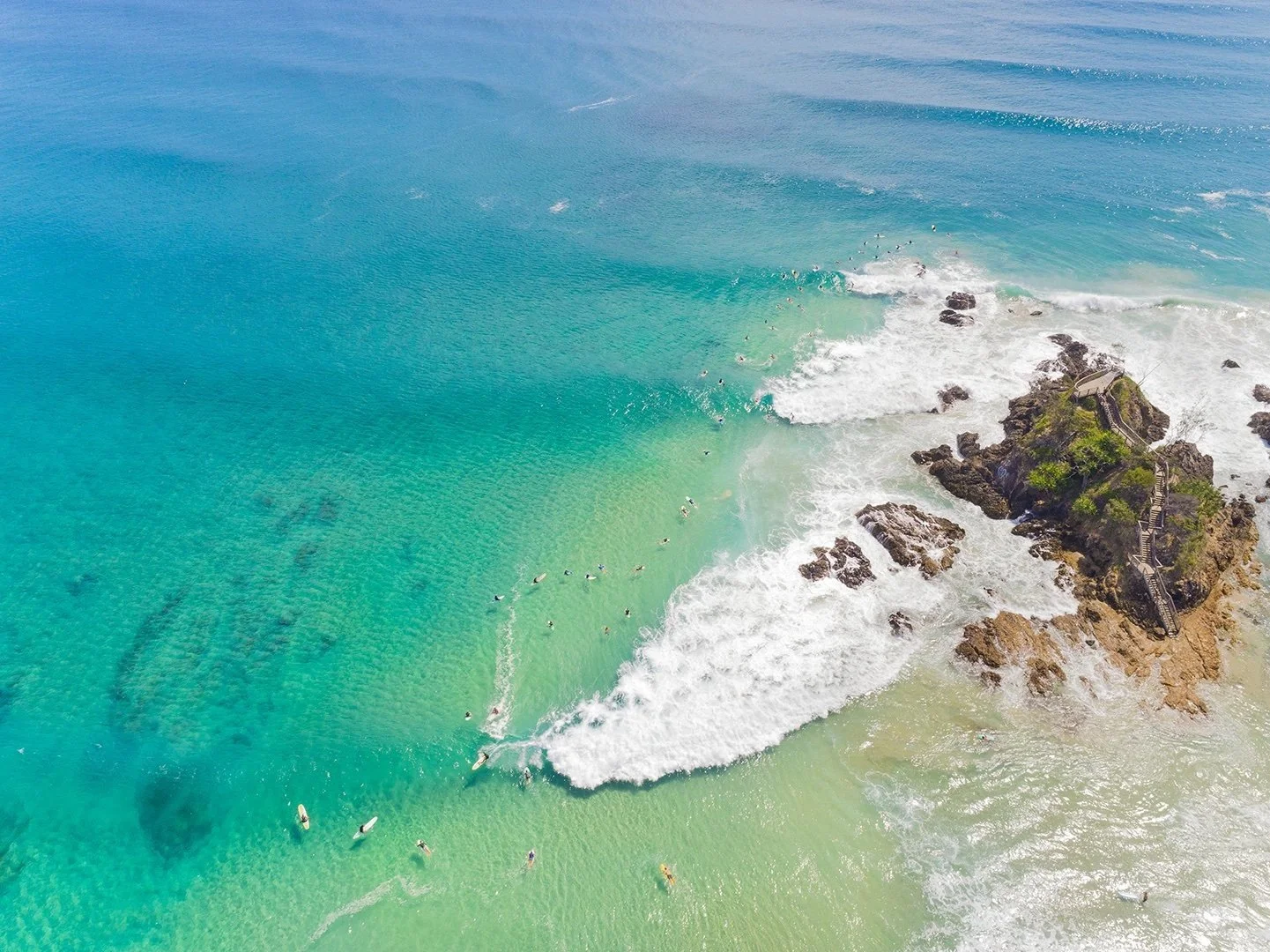 An aerial photo of Byron Bay's The Pass surf spot with rocky outcrop
