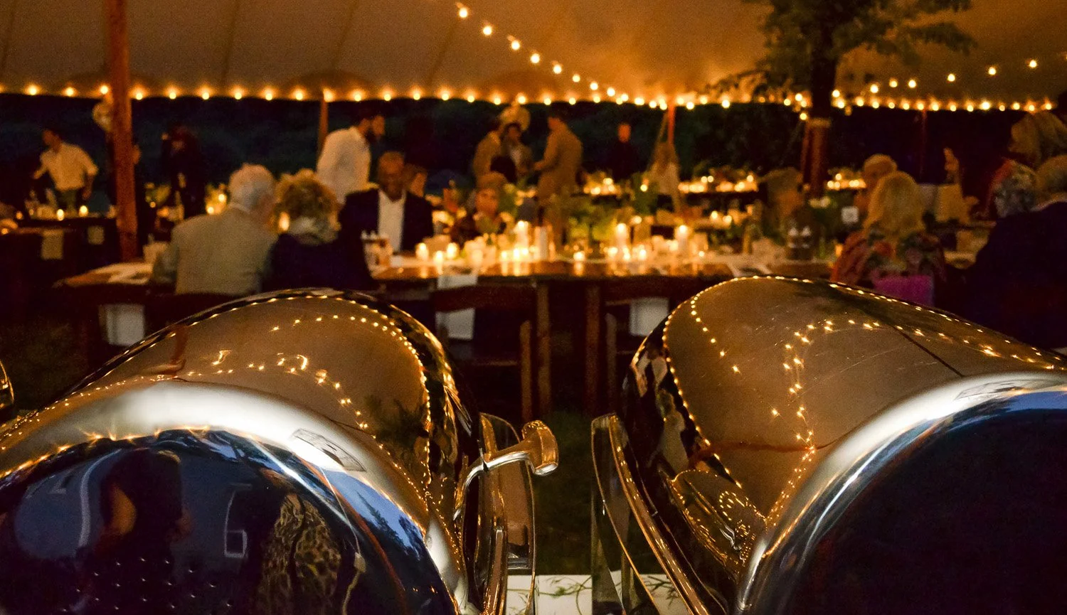 Catered buffet service under string lights at wedding