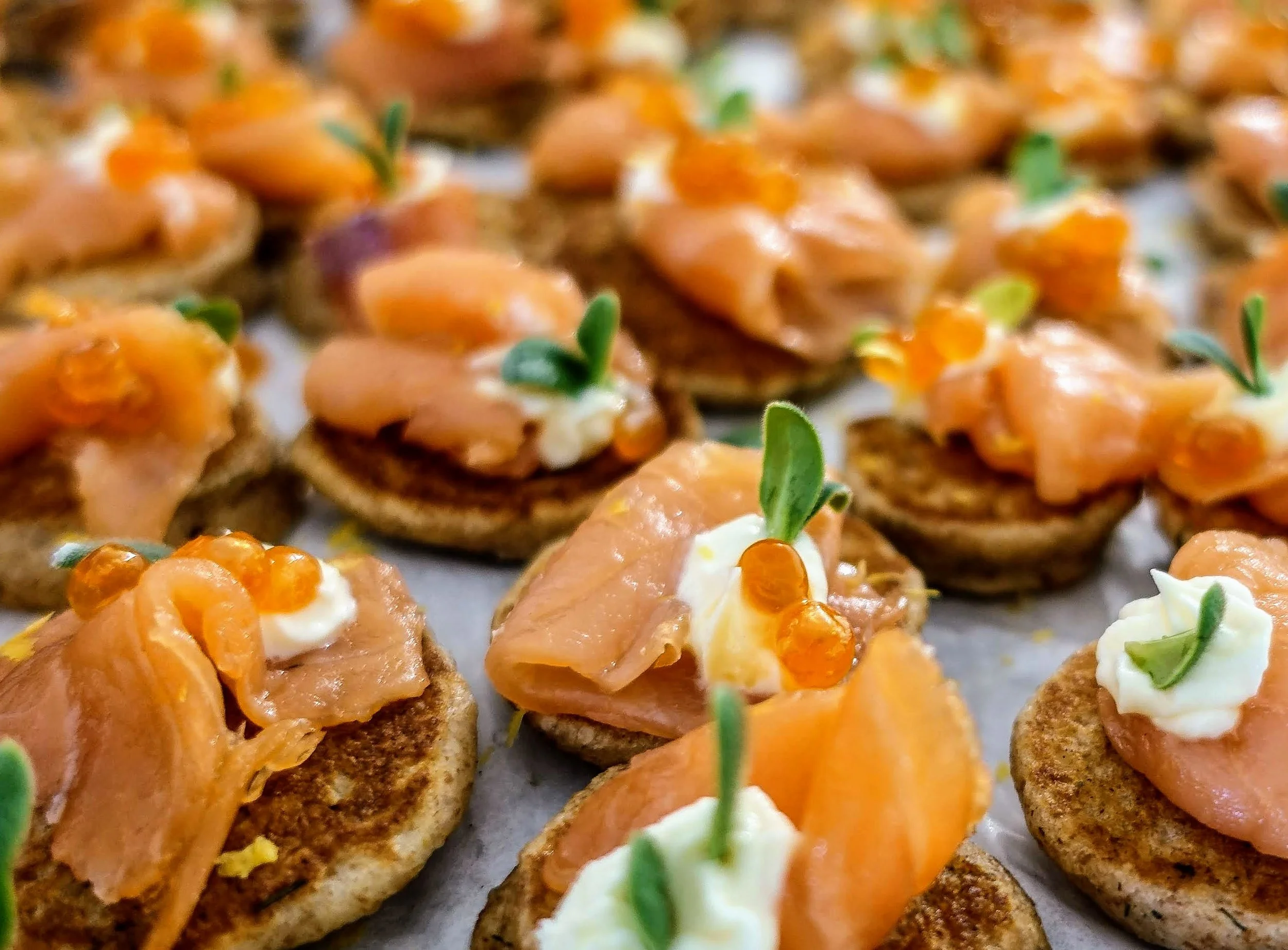 Smoked salmon blini appetizers with caviar for event catering