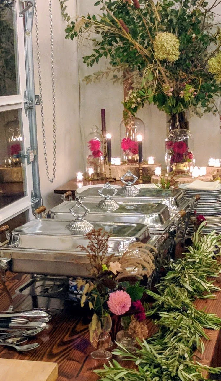 Buffet table decorated with greenery and mason jars
