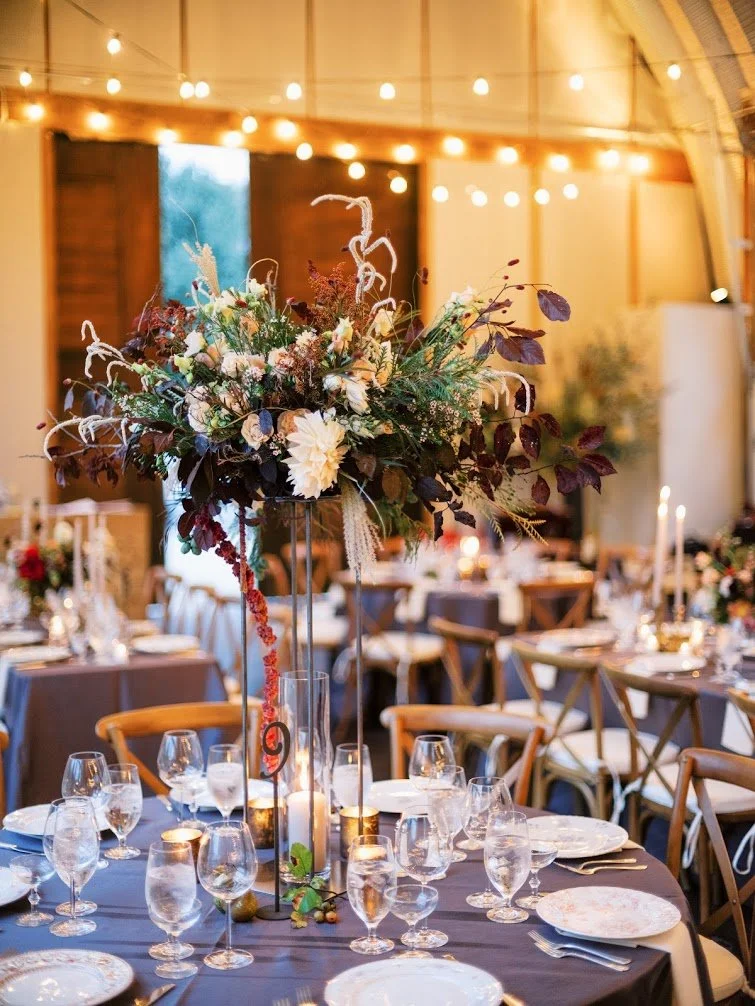 Towering floral centerpiece at wedding reception table