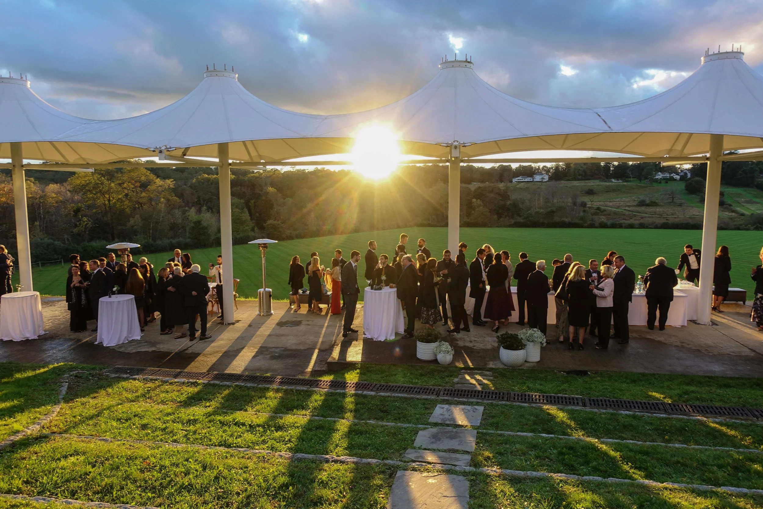 Sunset wedding ceremony at pavilion cocktail hour in Kirby Hill Farm