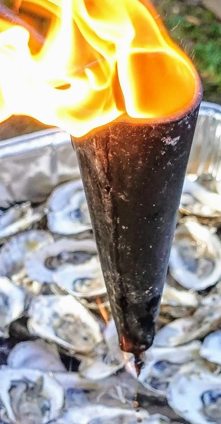 Flaming tallow poured over oysters, open-fire technique