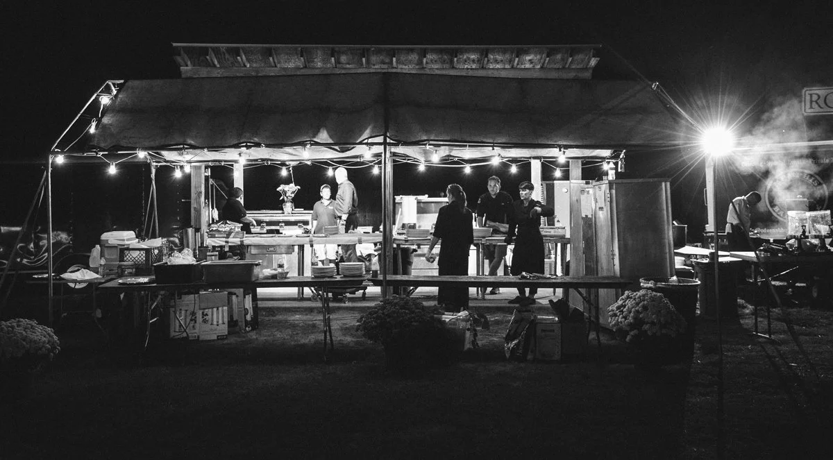 Catering staff working night event under string lights