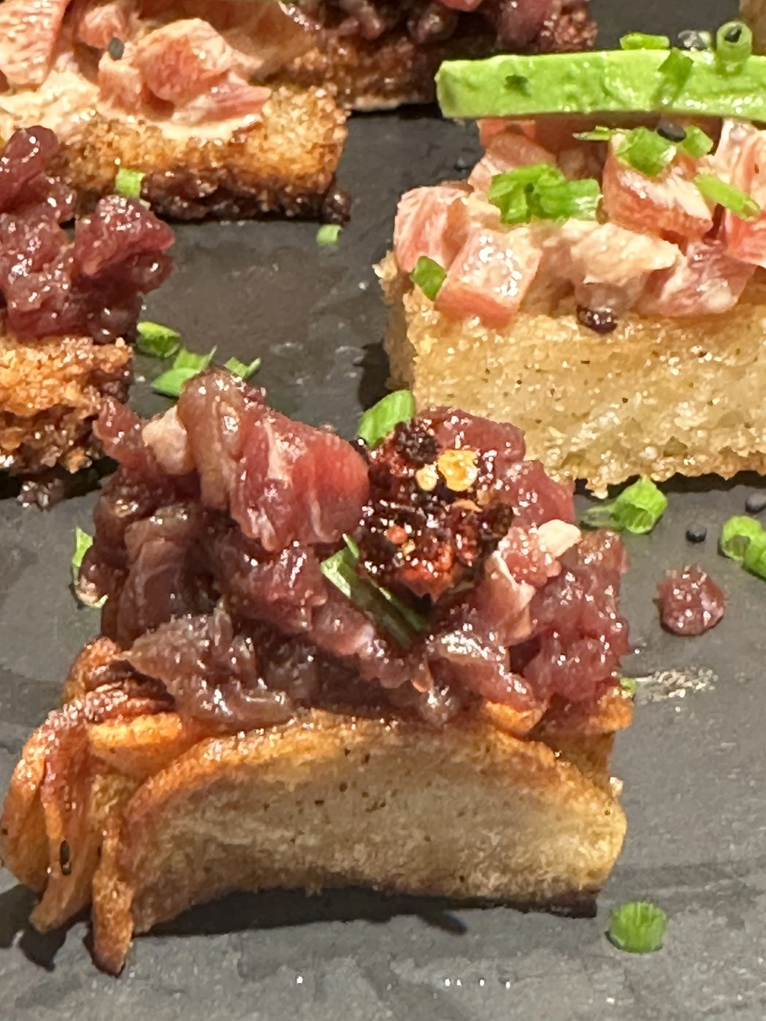 Steak tartare appetizer with chili crisp on crisp hasselback