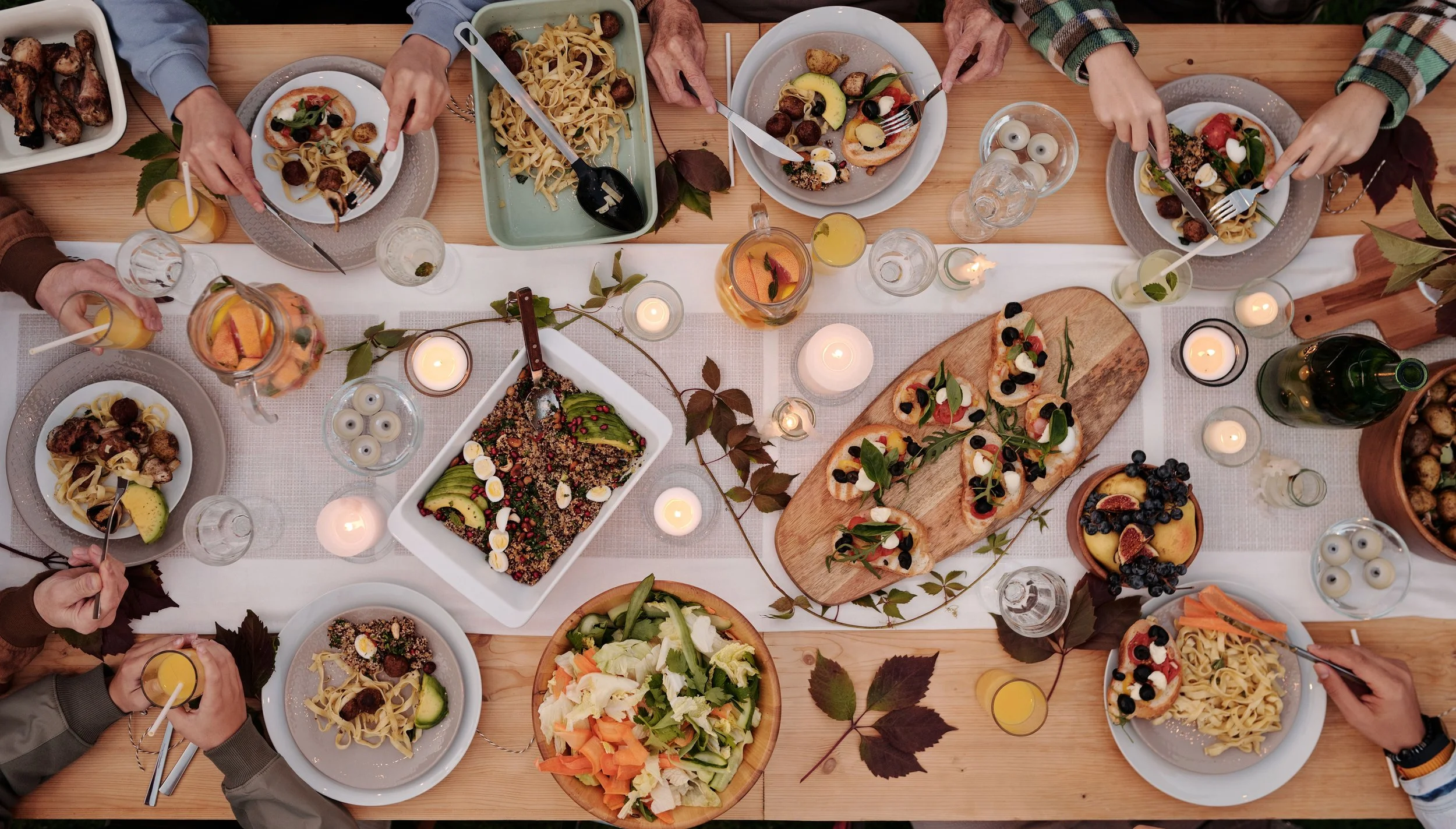 A dining table set up with variety of dishes to pick with while having plated dinner