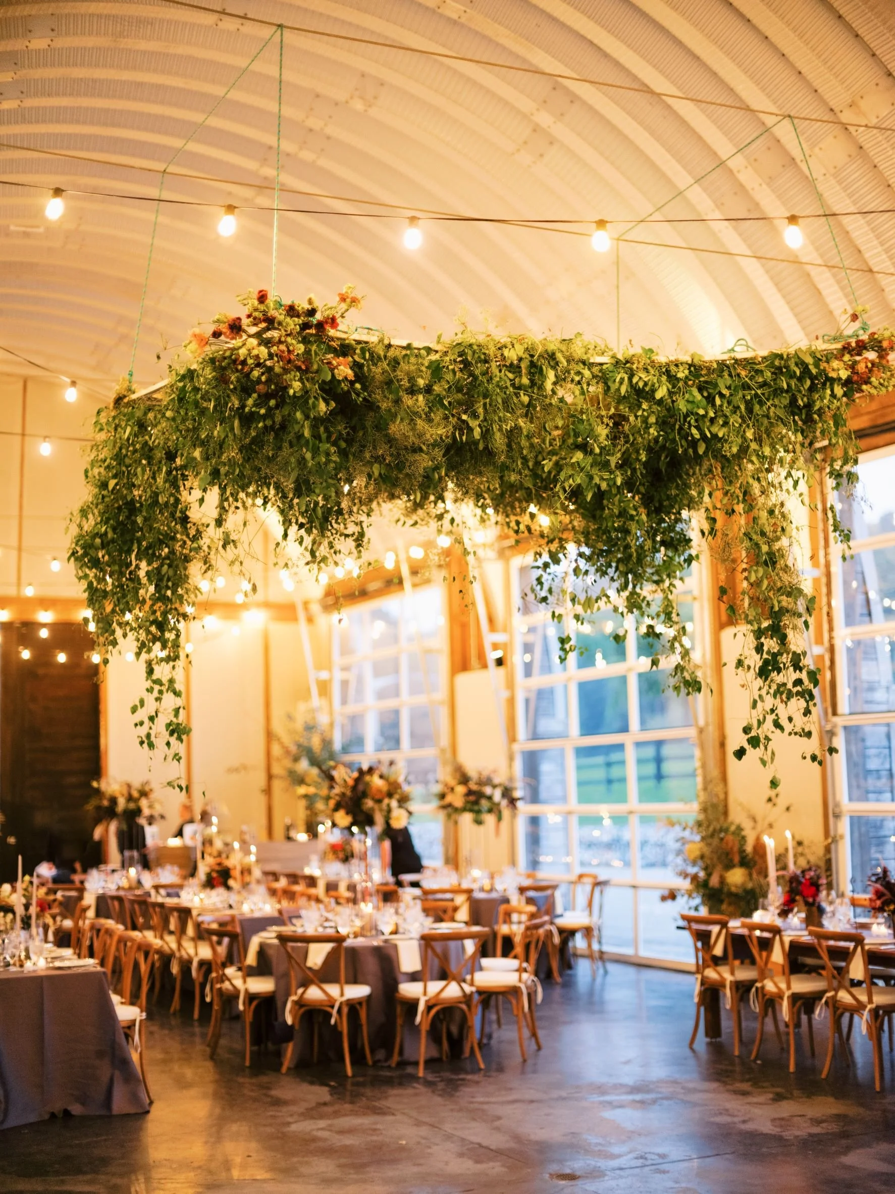 Floral chuppah over dance floor at wedding reception