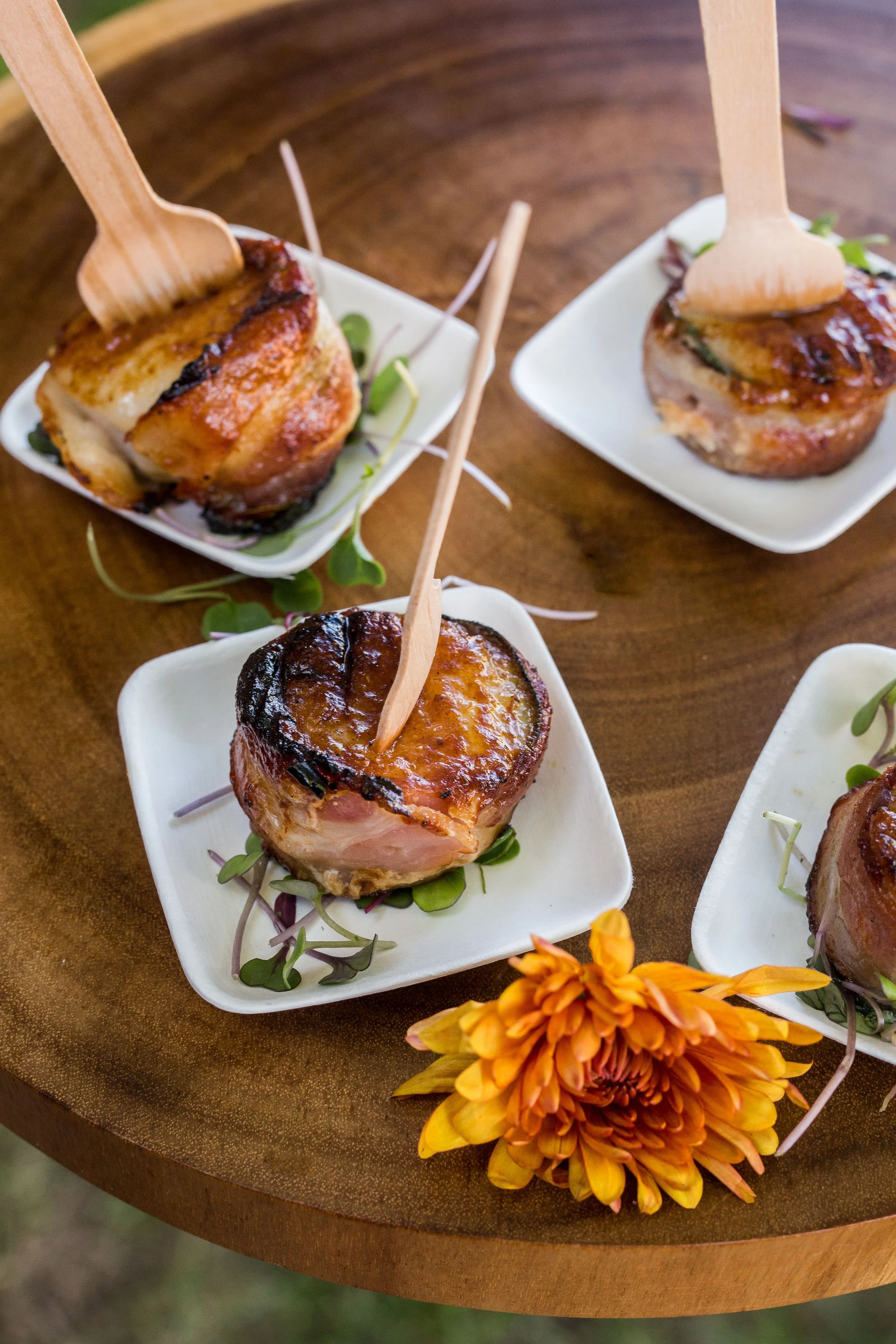 Bacon-wrapped scallops seared on charcoal, BBQ catering appetizer