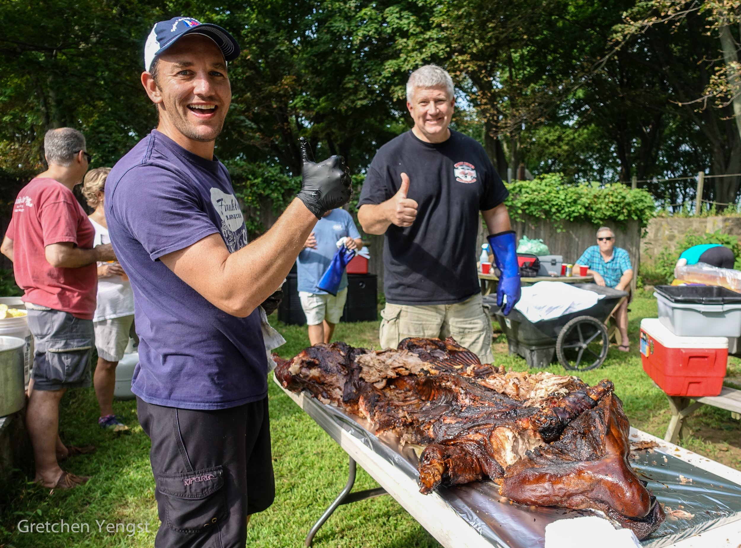 Catering team celebrating whole pig roast at event