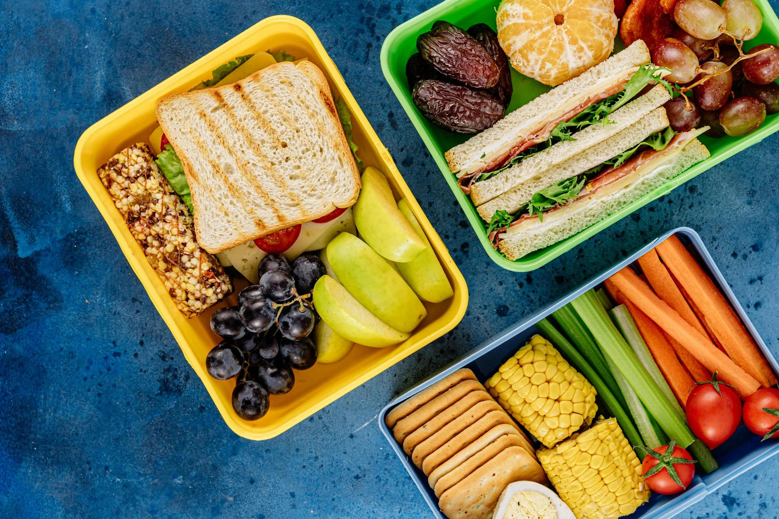sandwiches and snacks in colorful containers