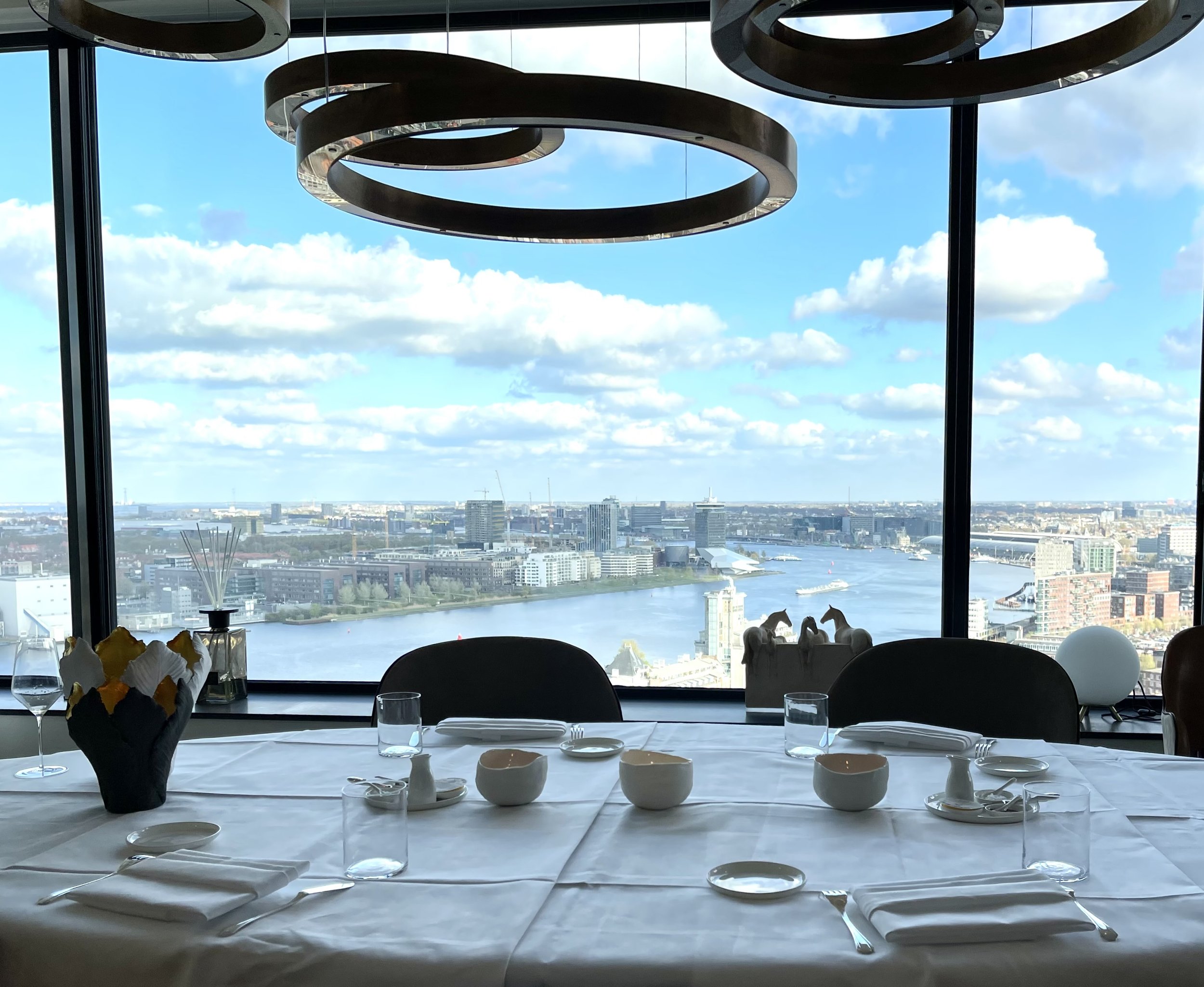     Private dining table overlooking the city and water, prepared for an intimate Alma Nómada experience.