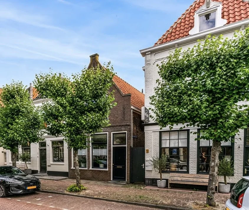 Historic street in Hoorn, the Netherlands, setting for a large private dining experience by Alma Nómada Studio.