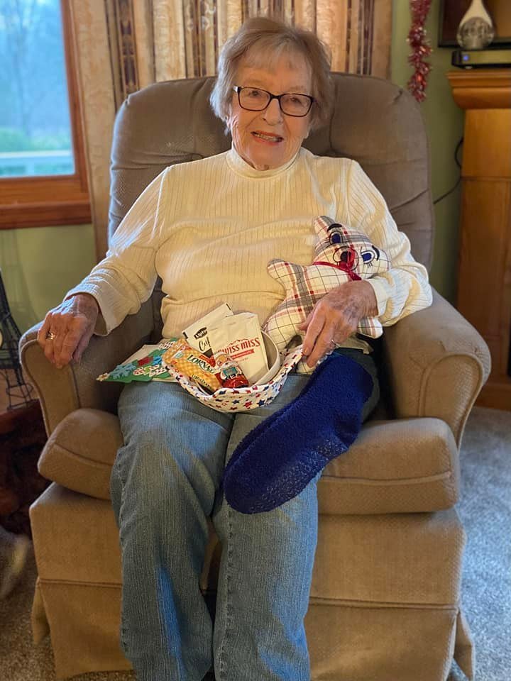 Betty Backman with gifts.jpg