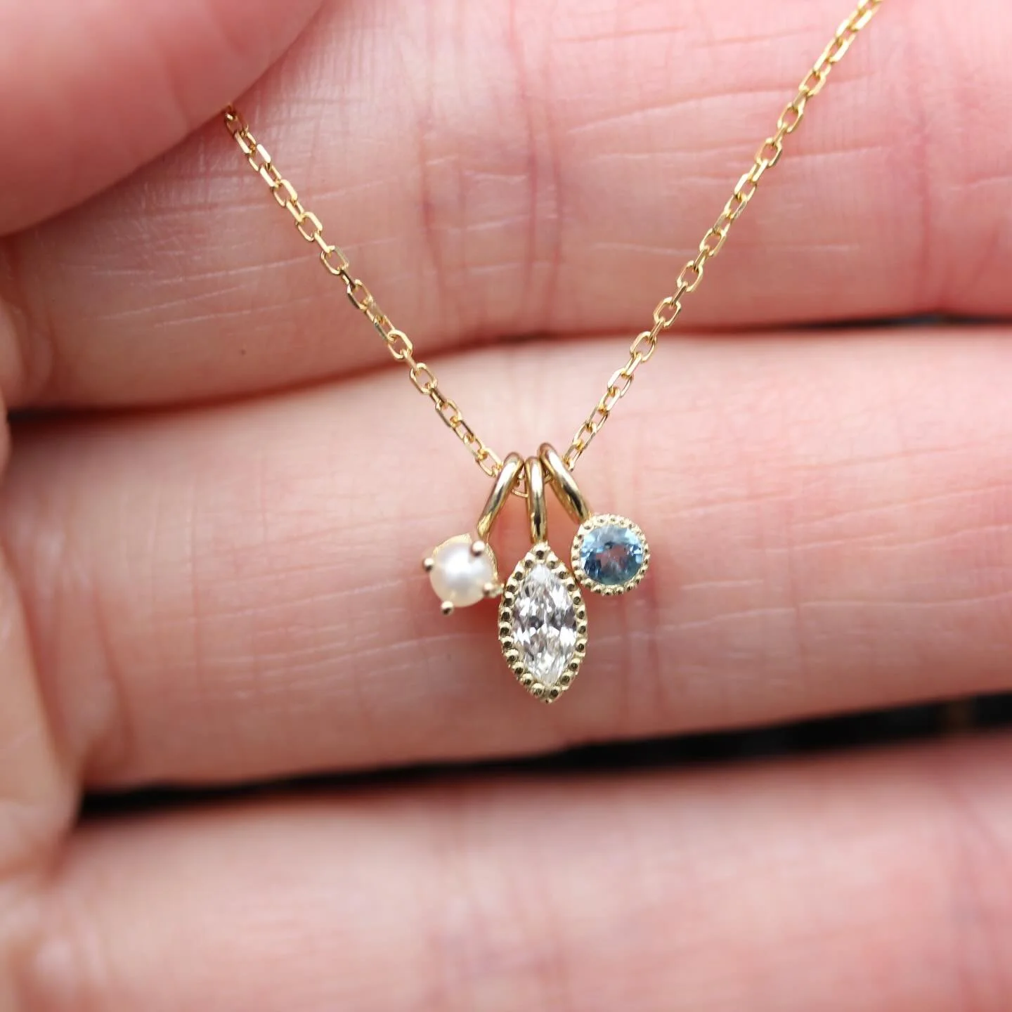 One of my favorite pieces of jewelry in the shop right now is this necklace by @jenniekwondesigns ✨ Featuring a marquis diamond, pearl and aquamarine, it is the most delicate little piece. Snatch it up before I decide to keep it 🤪 #jenniekwondesigns