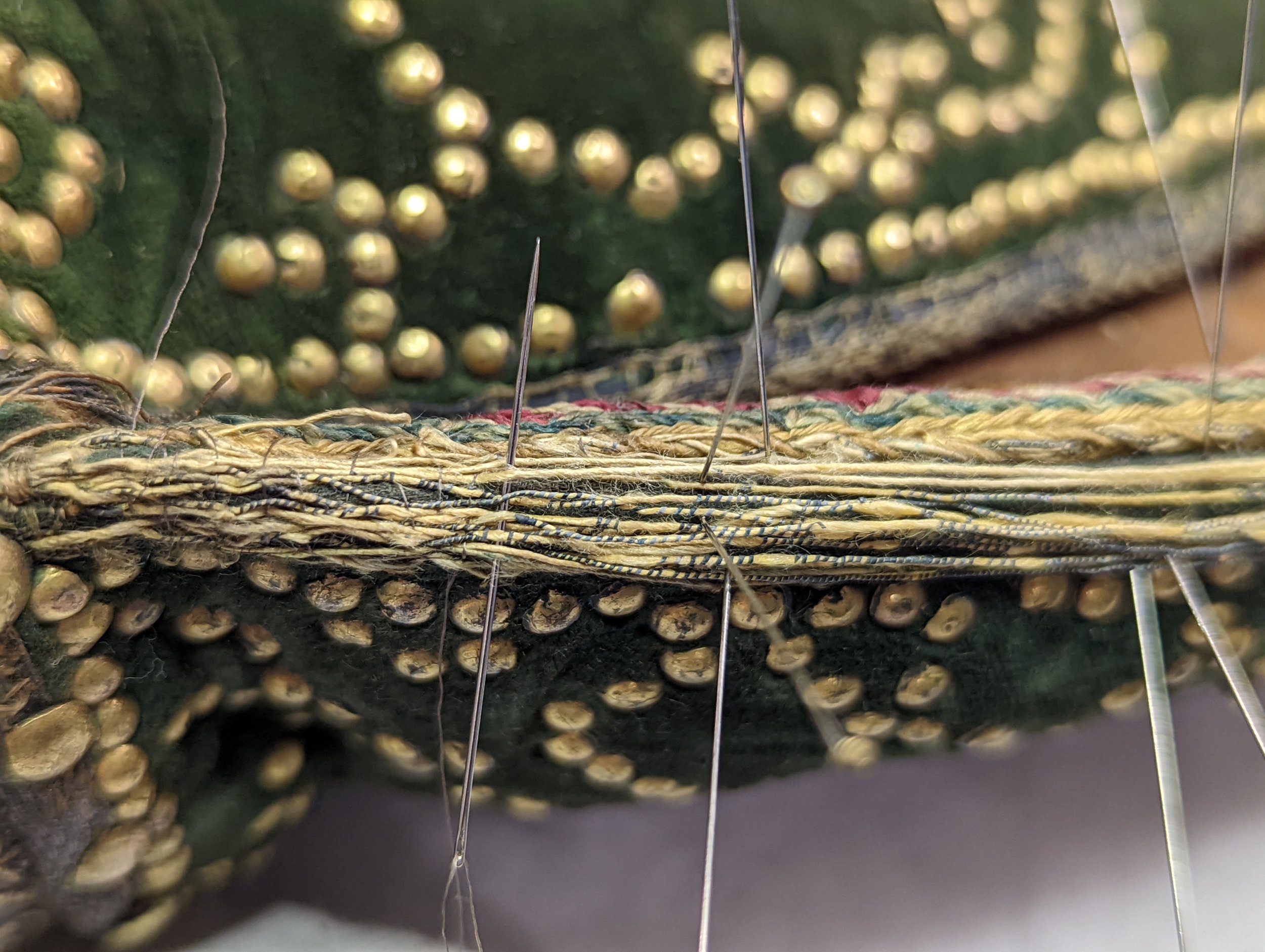  Weaving the needle over and under in an imitation of a plain weave, I was able to secure the loose threads back to the surface.  