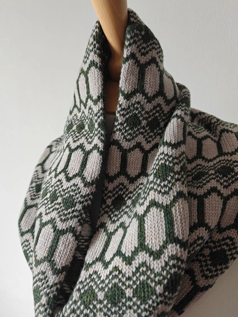 Strandhill wool snood in moss green and light stone colourway. Photographed on a mannequin, designed & knitted by Archipelago Knitwear