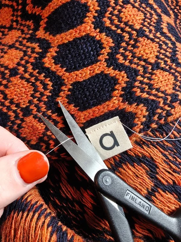 Close up fabric swatch of Strandhill wool snood, in navy & rust colourway. Designed and knitted by Archipelago knitwear