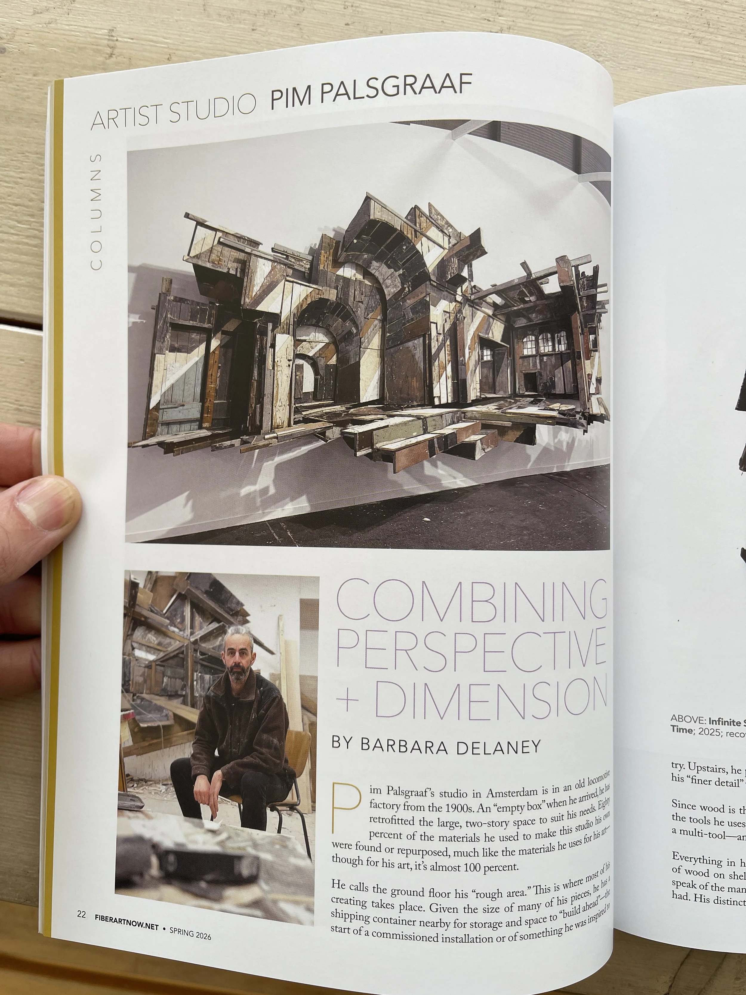 Cover of an art catalog featuring bold, holographic text reading "ANWIST" and red text reading "kunstcollectie Hogeschool Rotterdam" over a photo of a modern interior with large windows and a city view.