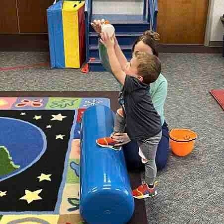 We can't help but  teach our patients to reach for the stars during their PT sessions! 
And at the same time, Sawyer is focusing on single leg stance balance and weight shifting for strength.  Go, Sawyer, Go!
If your little one needs help meeting mot