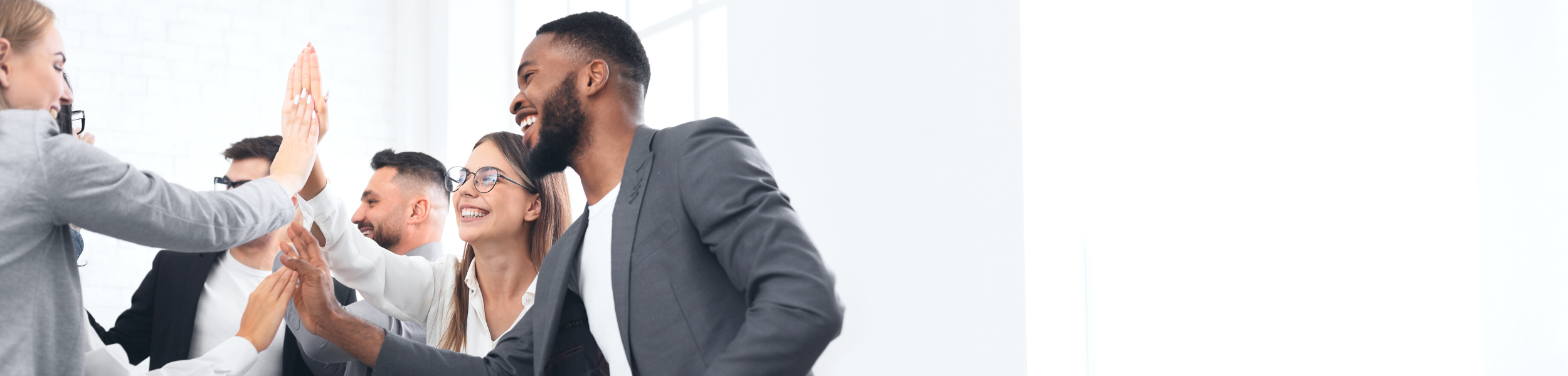 Business colleagues high-fiving in an office