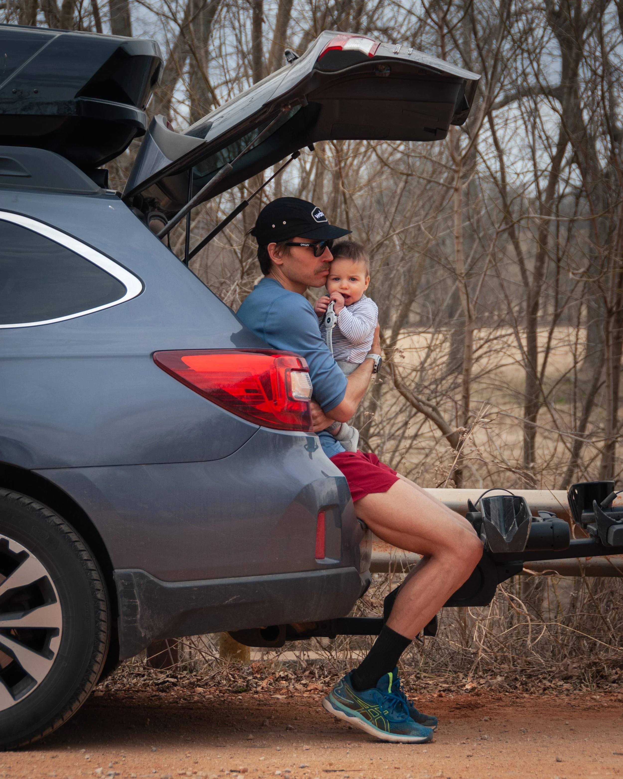 Ben holds Haak after an extraordinarily windy day on the dirt roads in Osage Mills. 