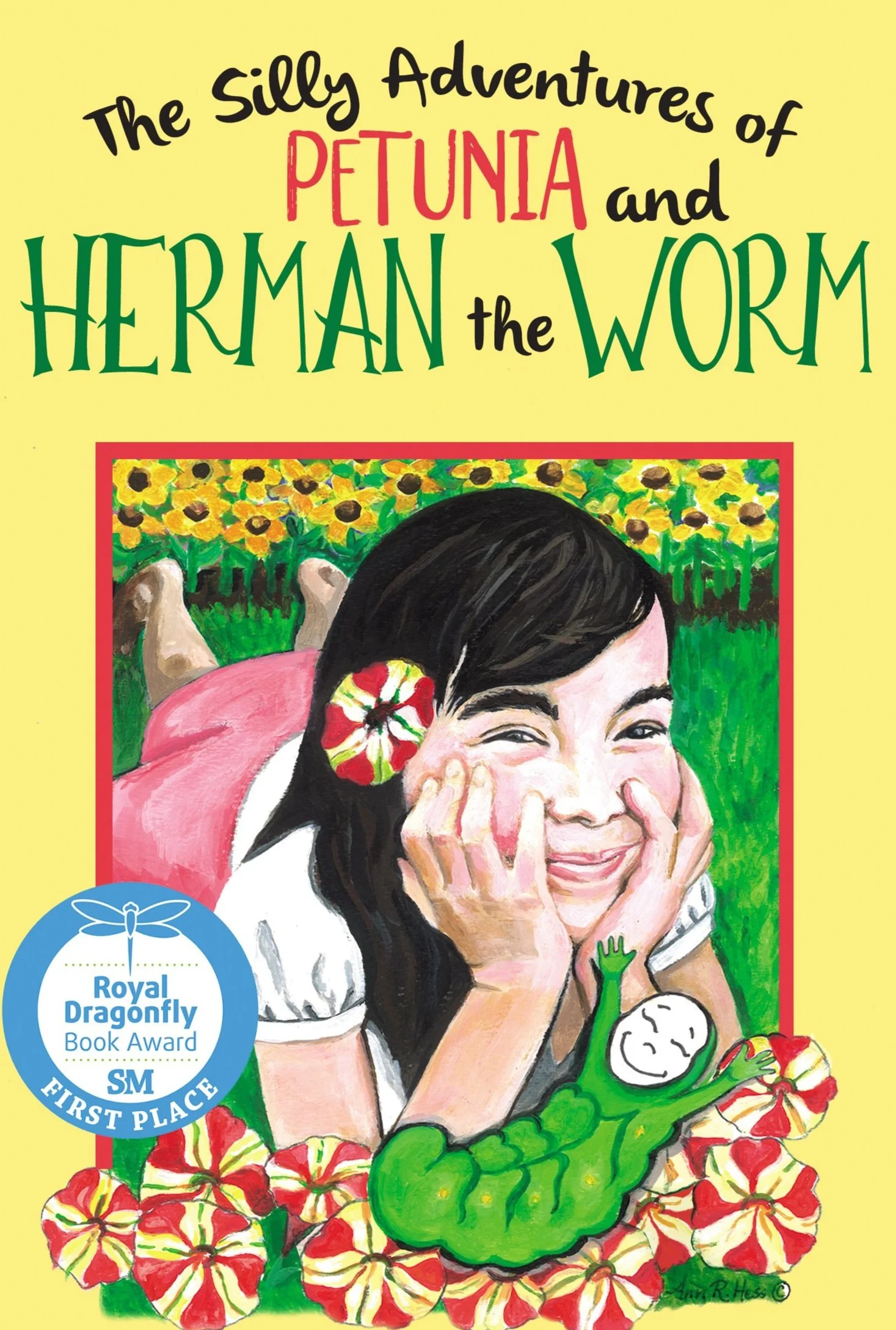 Children's book cover titled "The Silly Adventures of Petunia and Herman the Worm" featuring an illustration of a girl with a big smile, a flower in her hair, lying on her stomach in a field of sunflowers, holding her face with her hands, and a cartoon green worm with a smiling face.