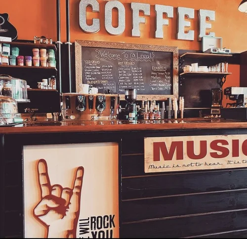 Inside @Local wear you buy your coffee. The wall is orange and has letters that spell out "coffee."