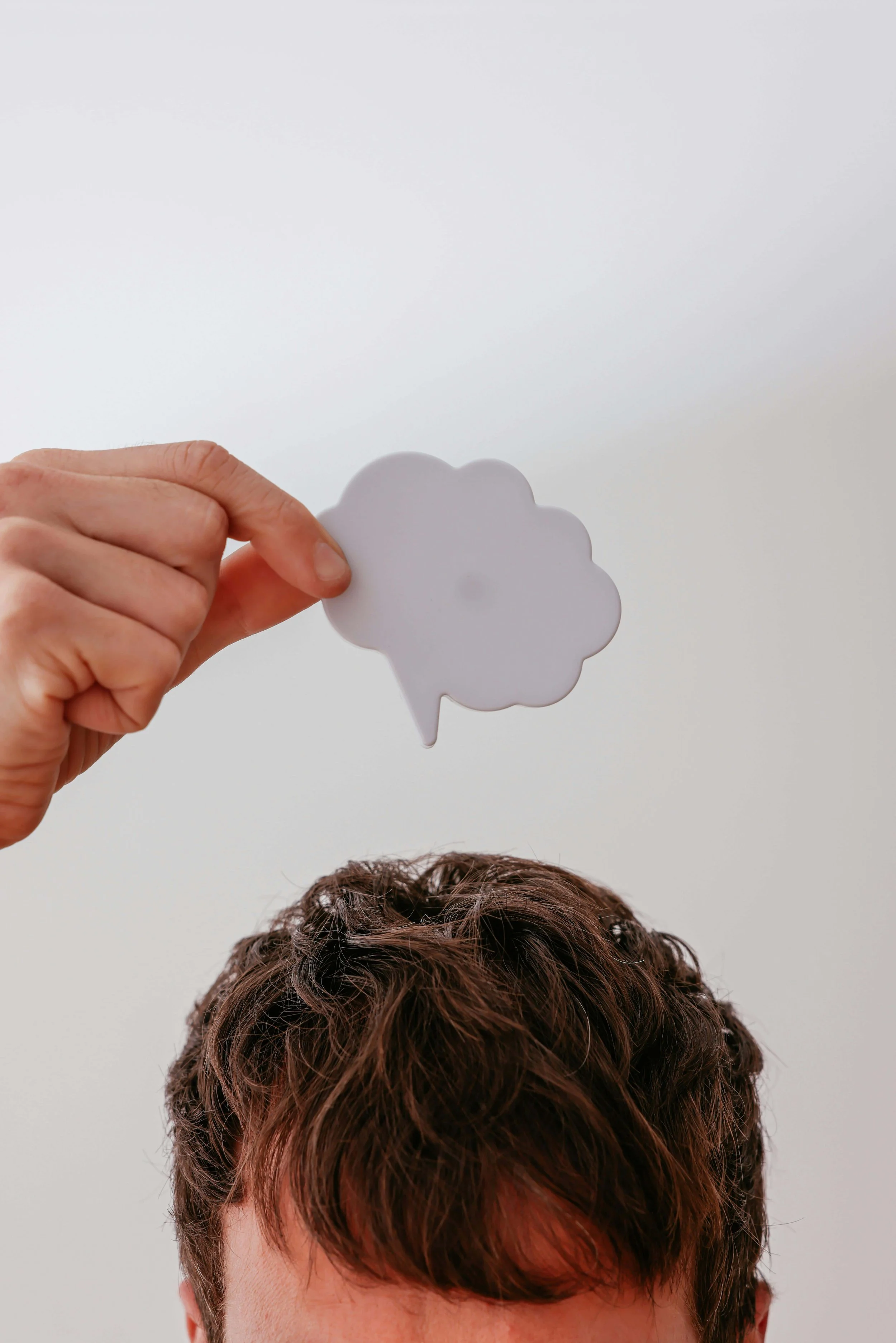 Person holding a thought bubble above their head