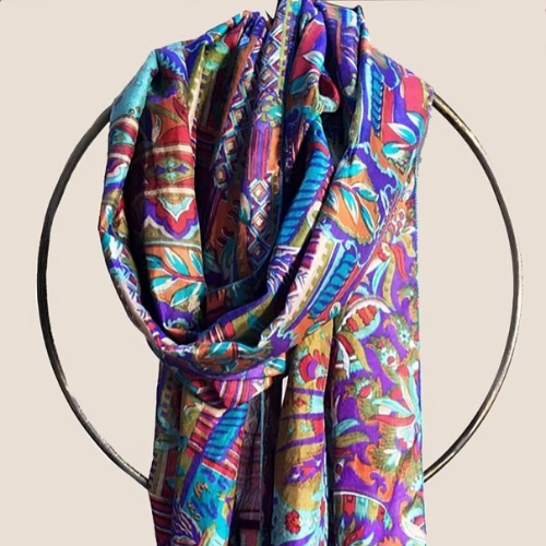 Colorful patterned scarf draped on a circular metal hanger