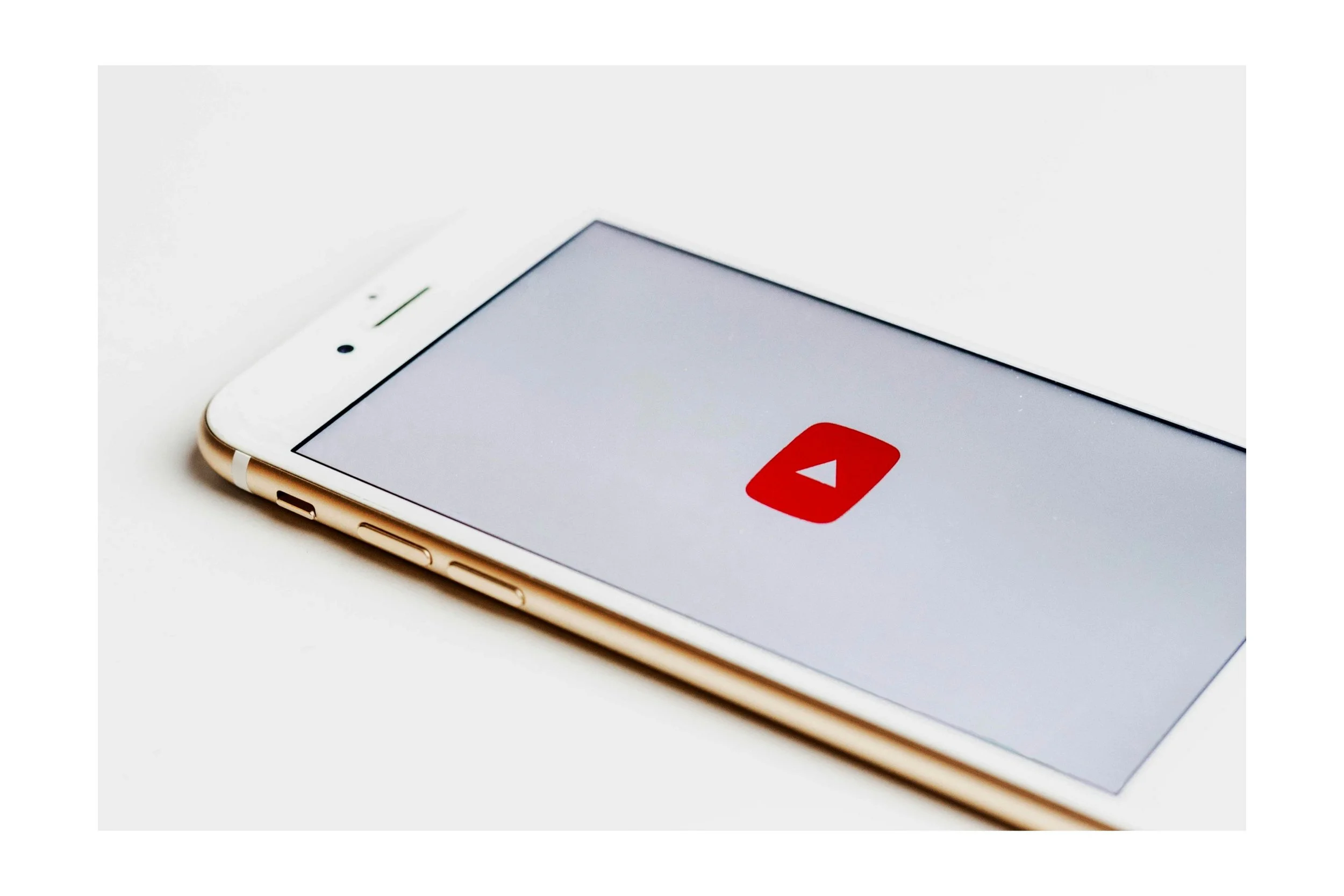 Smartphone displaying the YouTube app logo on the screen.
