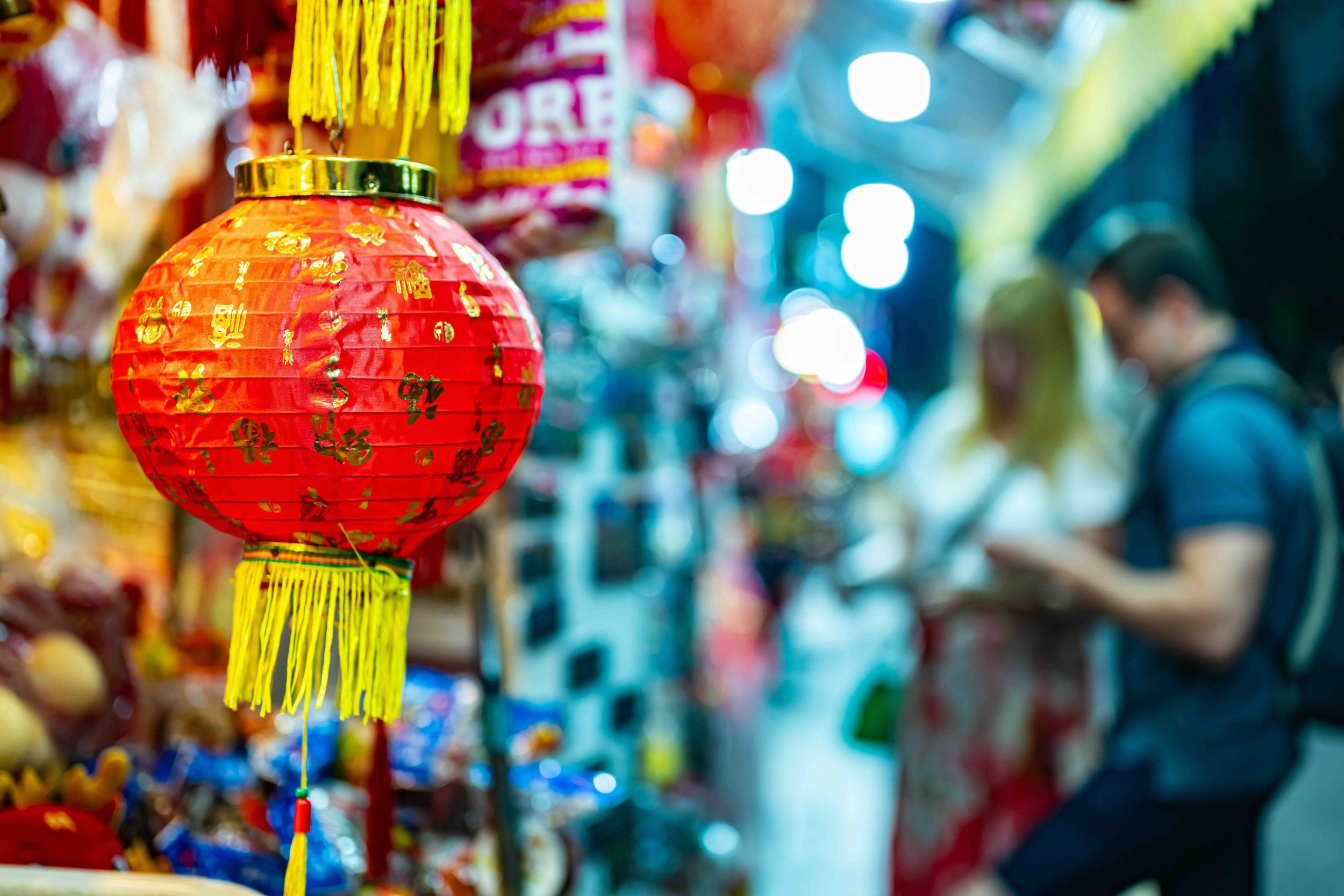 A traditional lantern glows in Chinatown, where students trace the stories of Singapore's earliest immigrant communities.