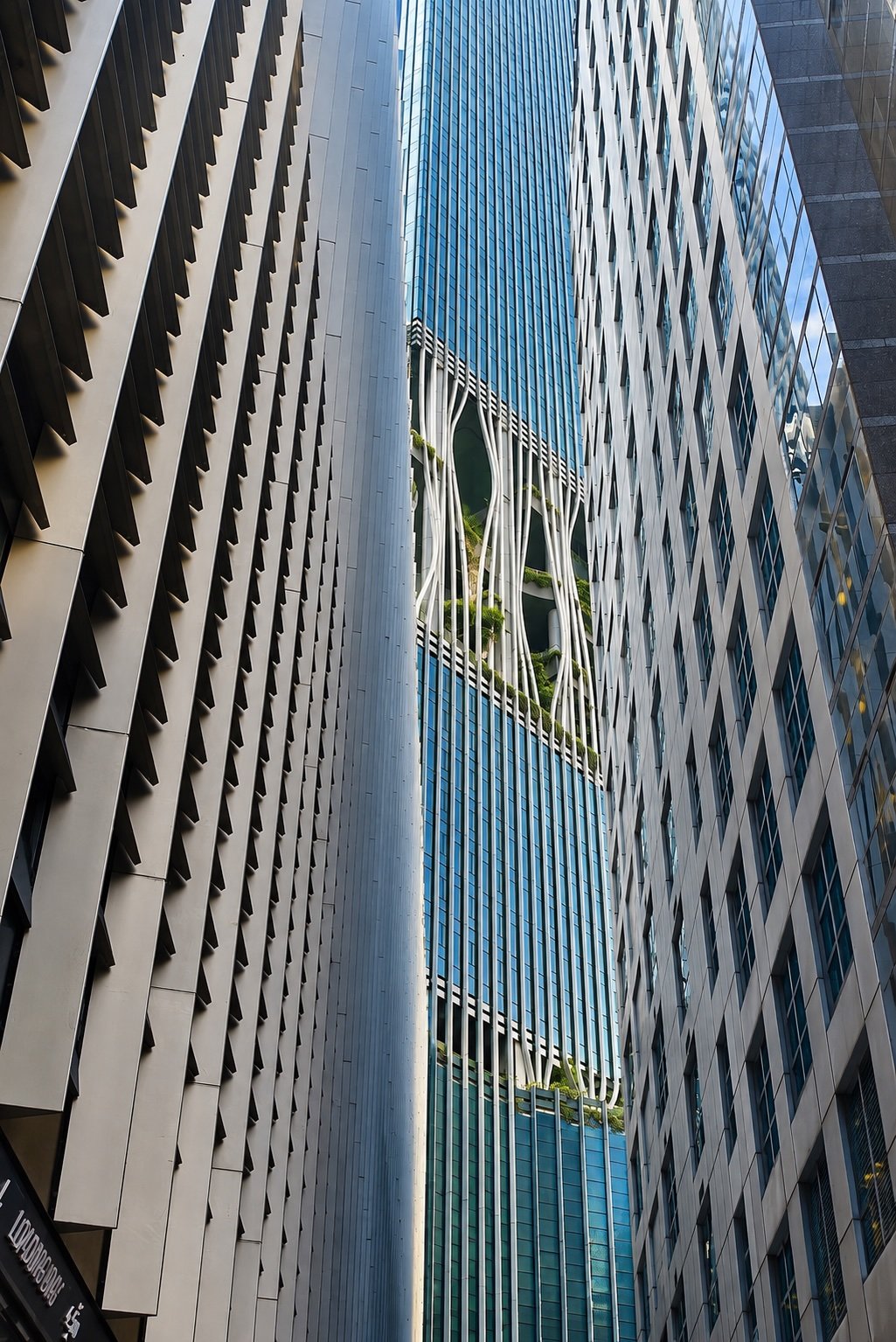 The striking glass facade of CapitaSpring, a leading example of Singapore's forward-thinking urban planning.