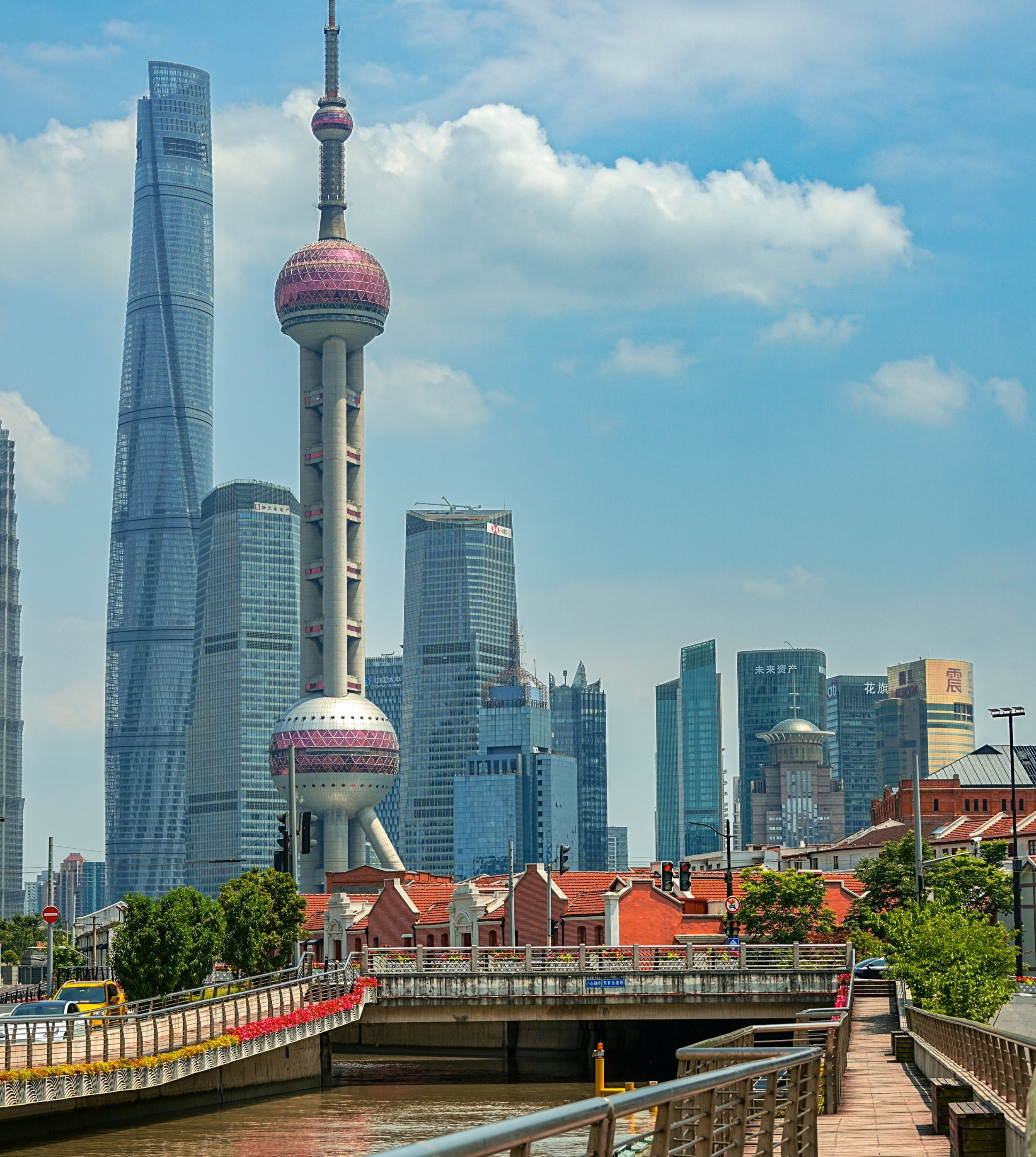 view of Shanghai’s famous Bund waterfront, showcasing colonial-era buildings set against a modern skyline