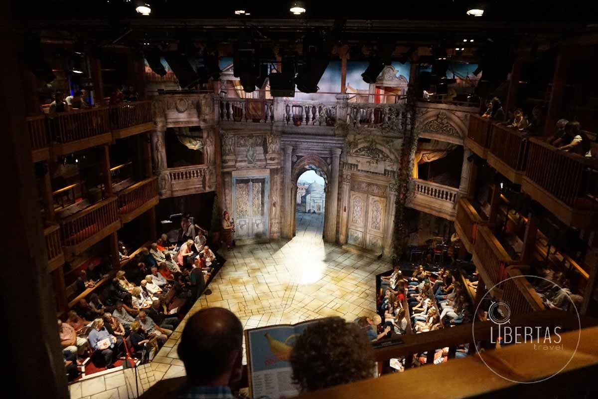 Swan theatre in stratford with it's dramatic lighting and quaint timber work, audience for live theatre