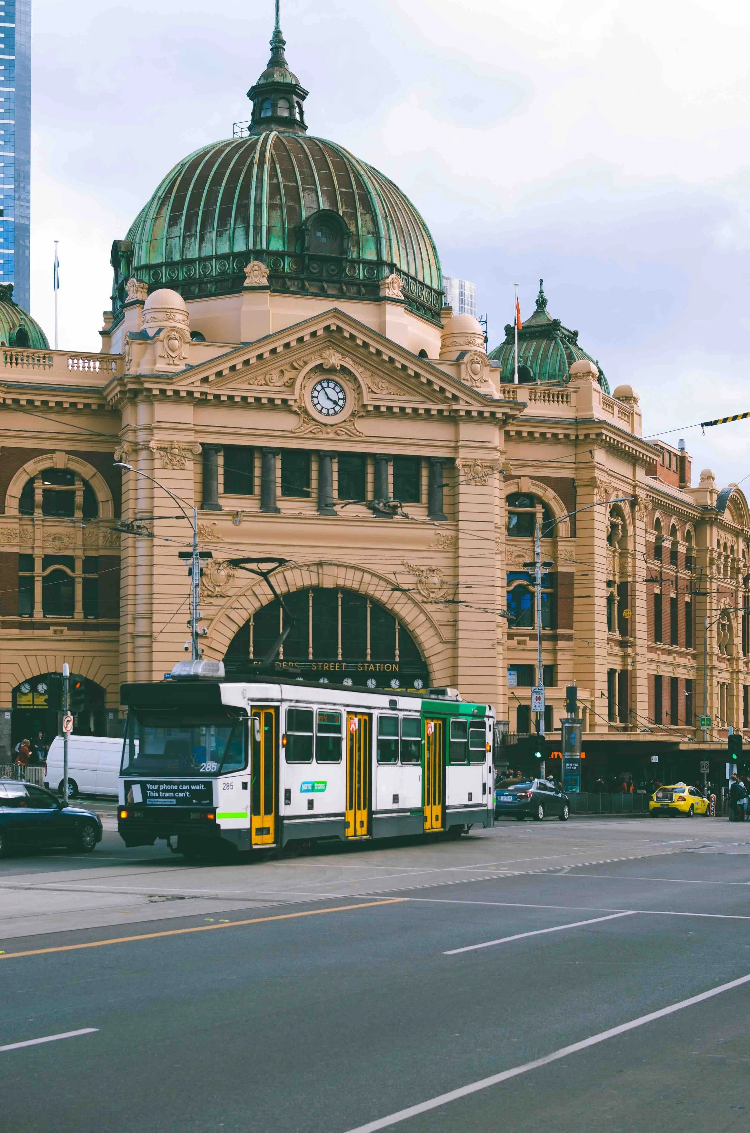 A Melbourne tram passing the iconic Flinders Street Station — a living lesson in urban planning, heritage architecture and transport on Libertas Travel's Melbourne high school excursions.