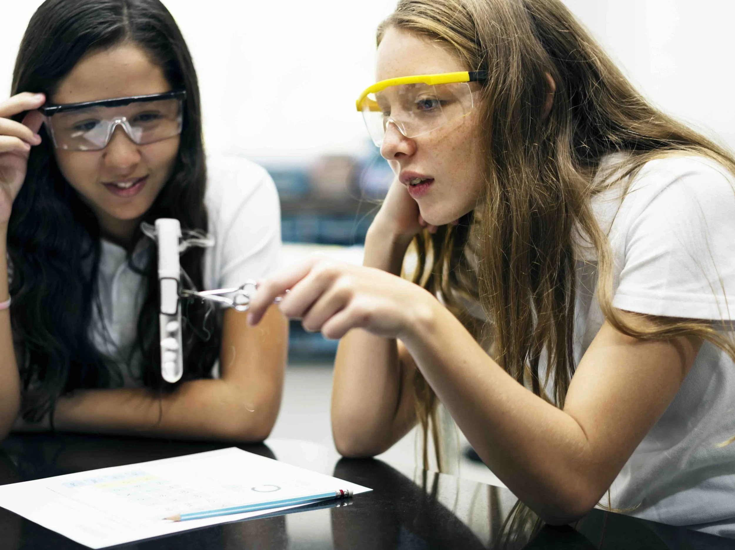 Two high school students in safety goggles conducting a hands-on science experiment — the kind of active, inquiry-based learning central to Libertas Travel's STEM-focused Australian school excursions.