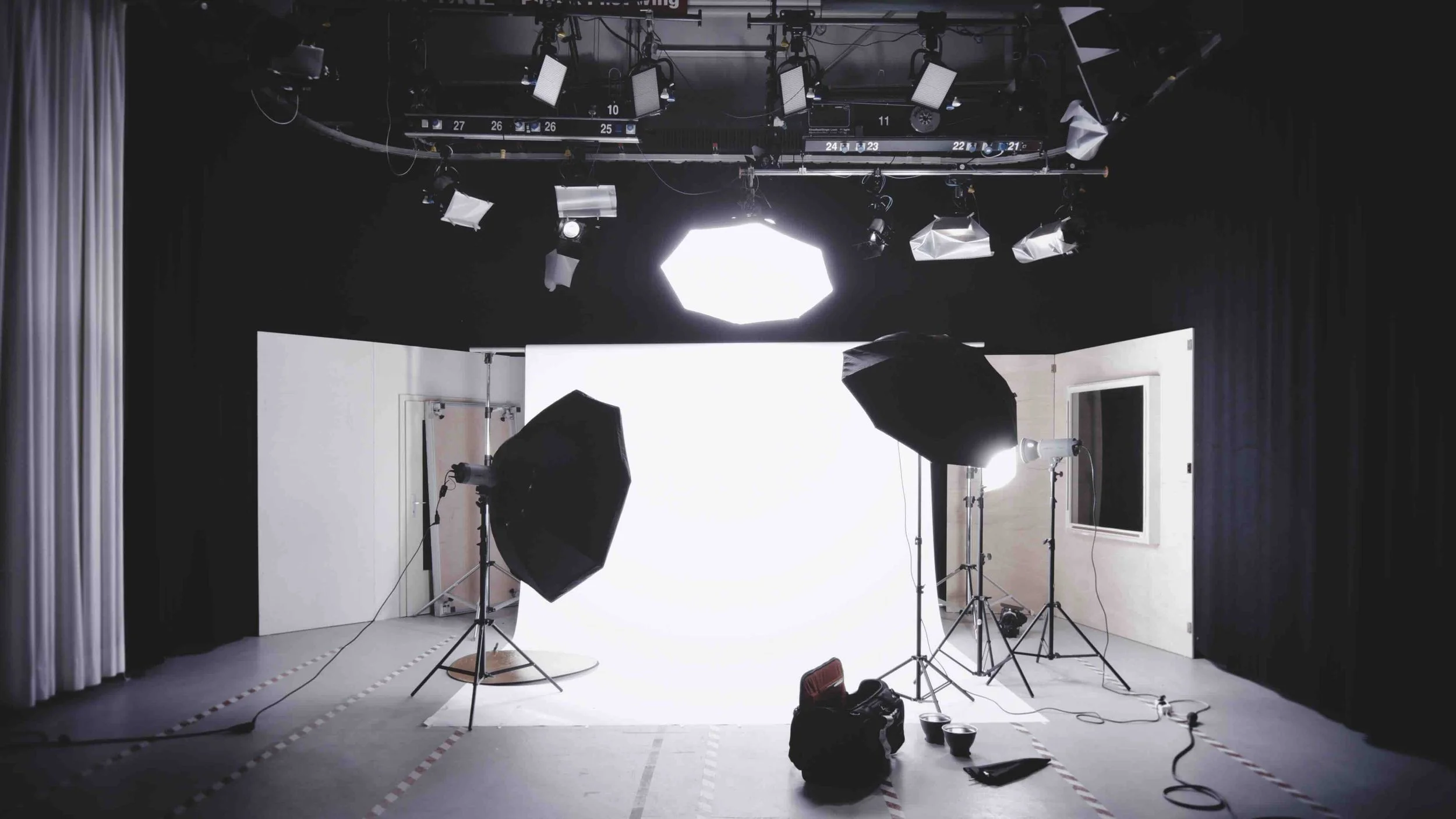A professional film and photography studio set up with softbox lights and a white cyclorama — the kind of industry-standard creative environment explored on Libertas Travel's Creative Arts and CAPA high school excursions.