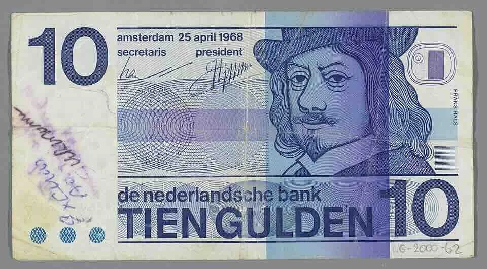 Amsterdam / Dutch currency history | Ten-guilder banknote (1968) featuring the portrait of Frans Hals, defaced with handwritten political inscriptions referencing Suriname's independence.