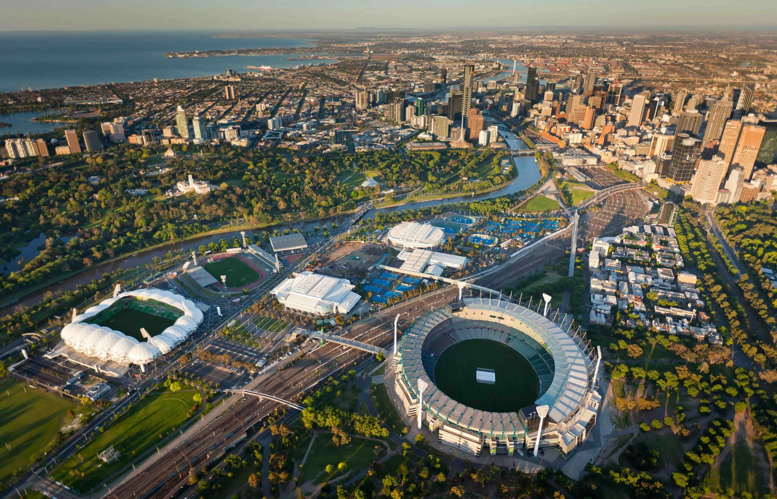 Aerial view of Melbourne's sports and entertainment precinct featuring the MCG, Melbourne Park and the Yarra River — explored by Australian high school groups on Libertas Travel's Melbourne curriculum-linked excursions.