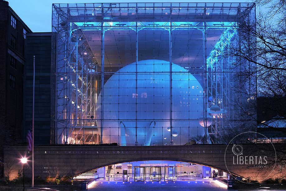 New York Planetarium looking through the glass at a massive installation lit by blue LED lights