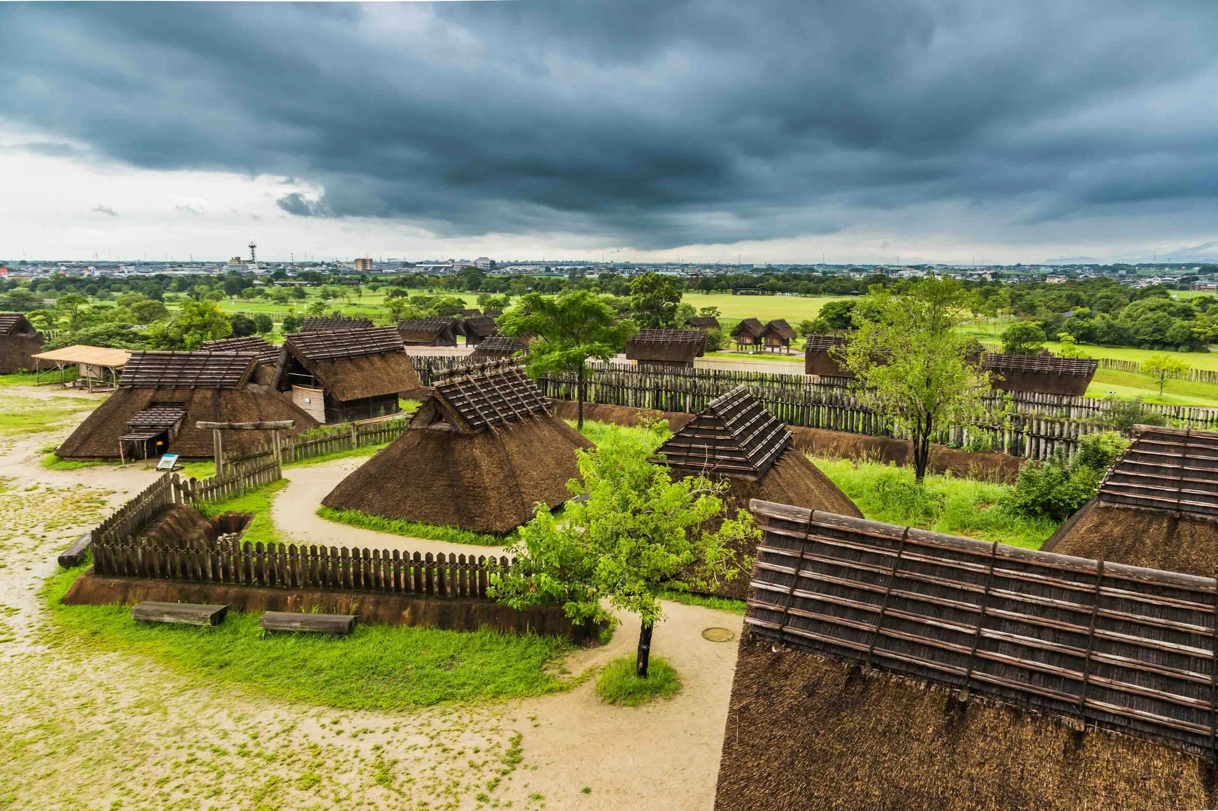 Reconstructed raised-floor granary storehouses at Yoshinogari Historical Park, Saga Prefecture, representing Yayoi period (c. 300 BCE–300 CE) architecture against a blue sky