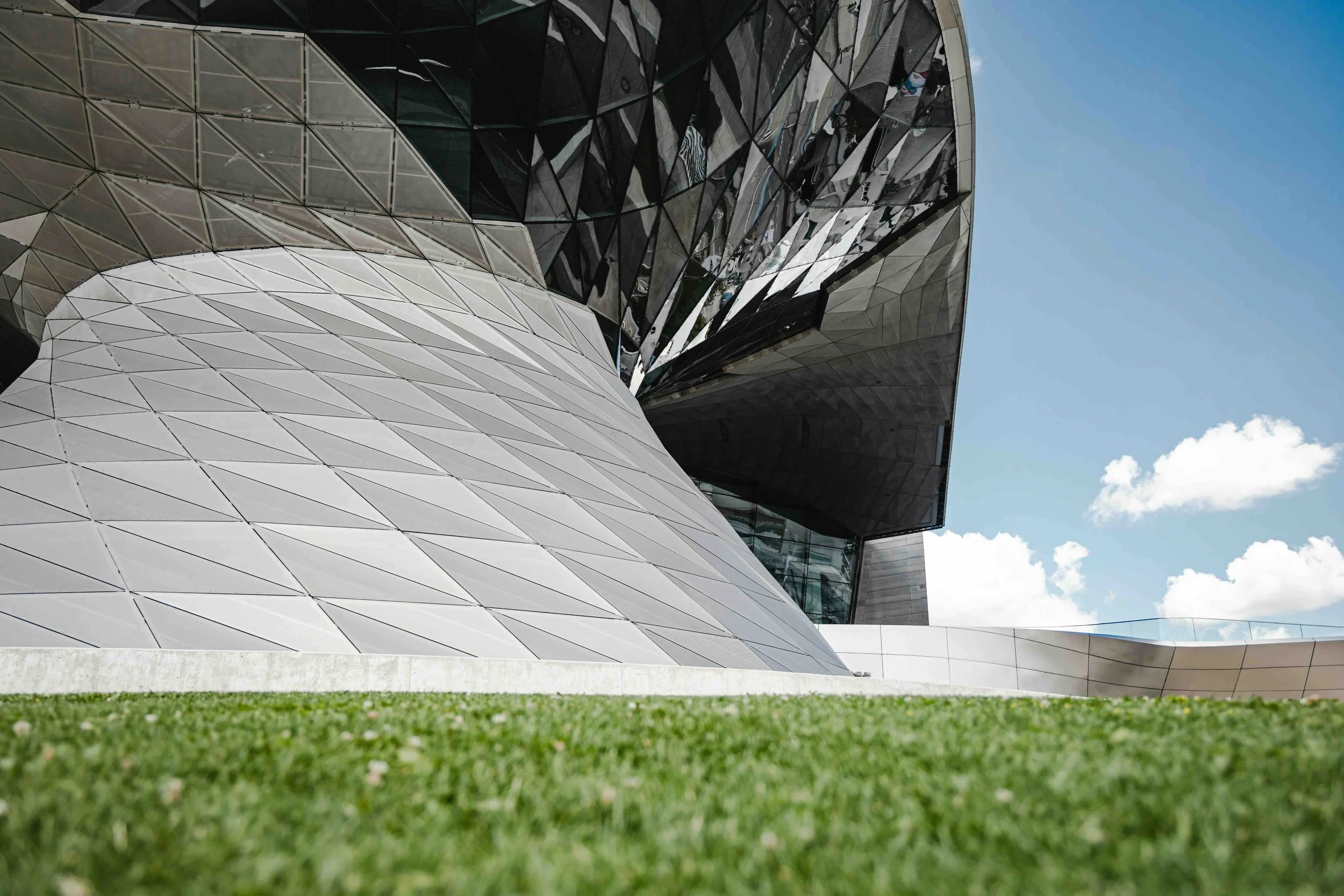 Days 8–10, Munich | Detail of BMW Welt's curved glass-and-steel architecture — BMW Welt production and manufacturing tour.