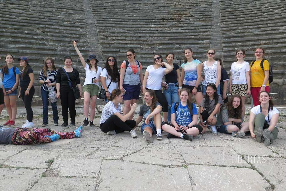 Student tour group at Delphi immersive on-site learning and interacting with one another happily
