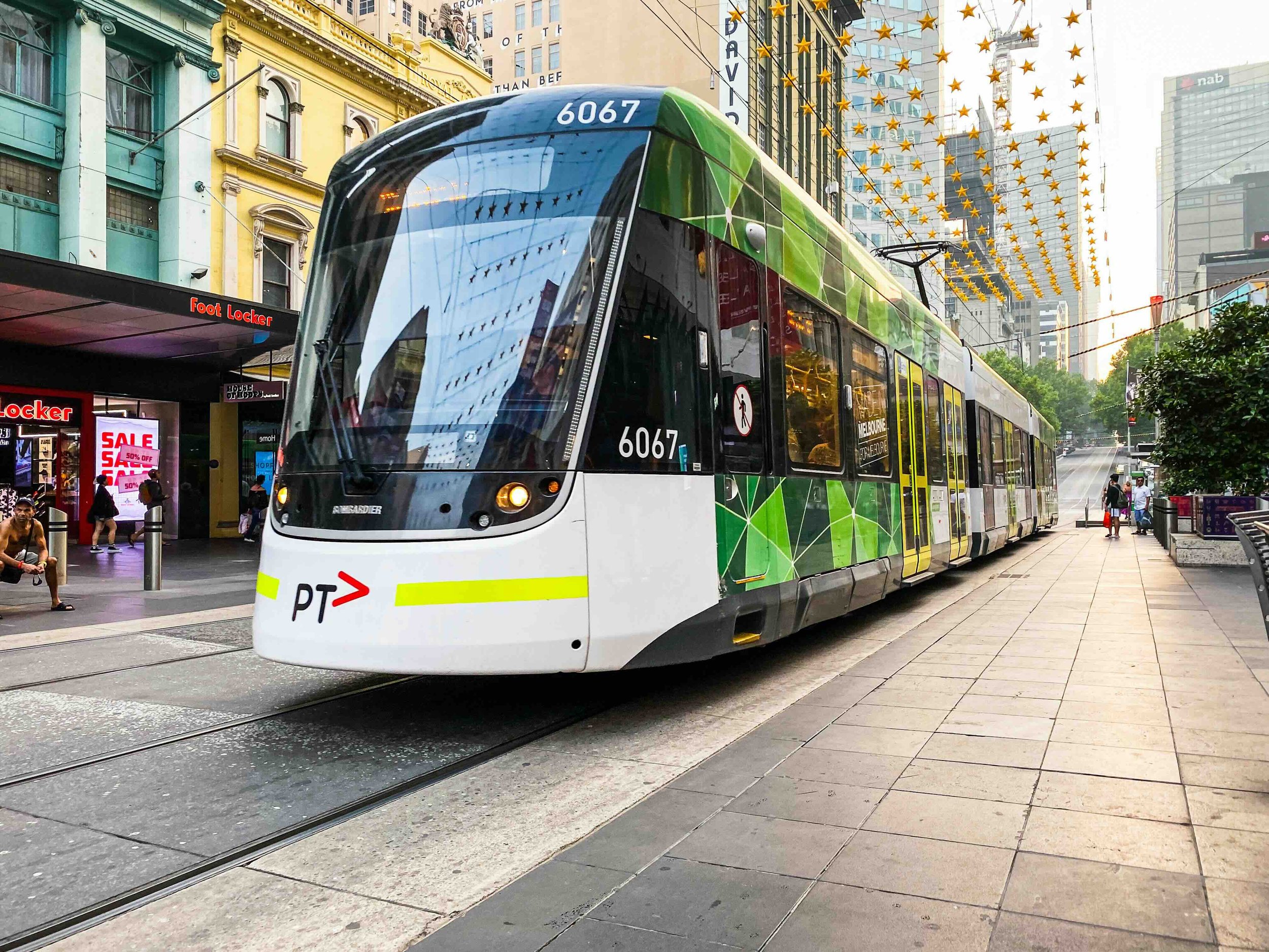 A modern Melbourne tram travelling through Bourke Street Mall in the CBD — an urban geography and culture experience on Libertas Travel's Melbourne high school excursions.