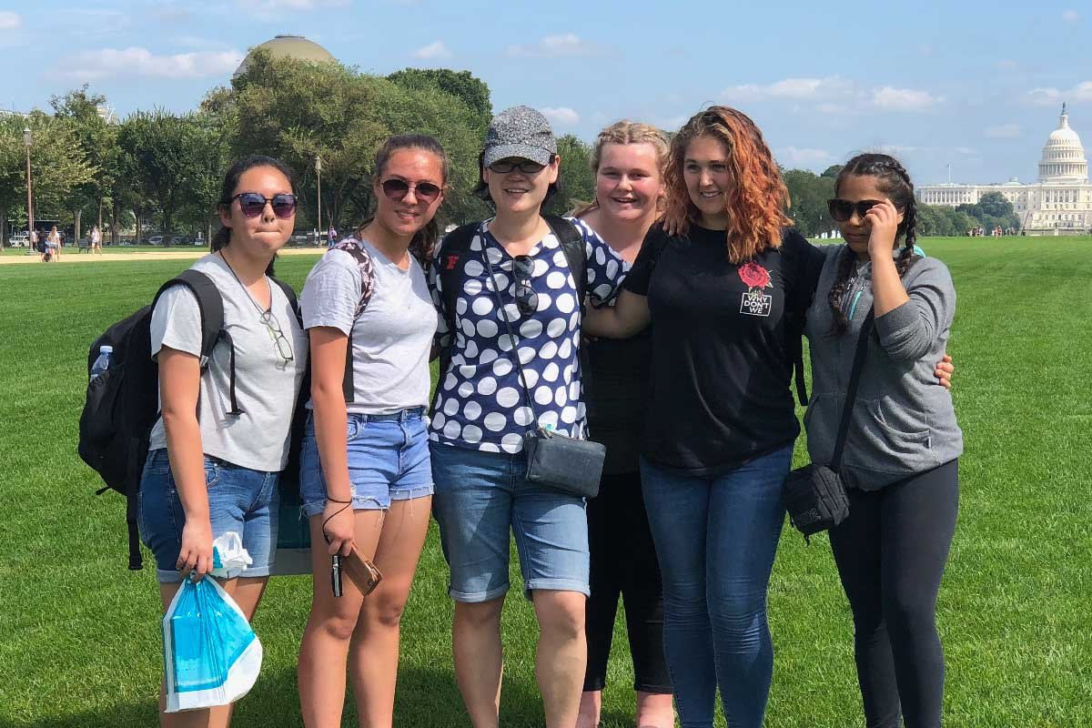 School group gathered together on the lawn - team building and social skills