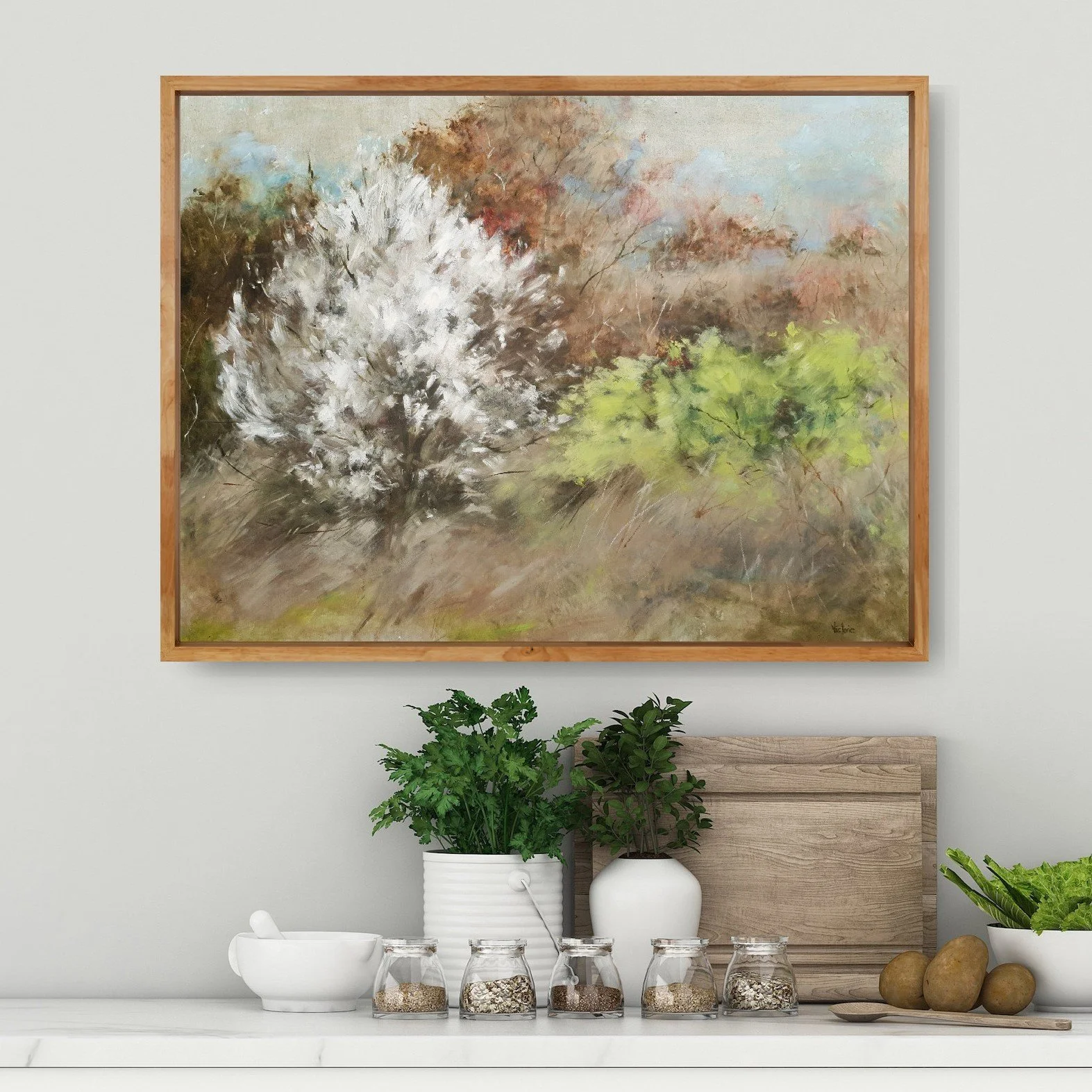 Country kitchen styling with soft abstract landscape painting in natural earth tones of light brown and white with cherry blossom.