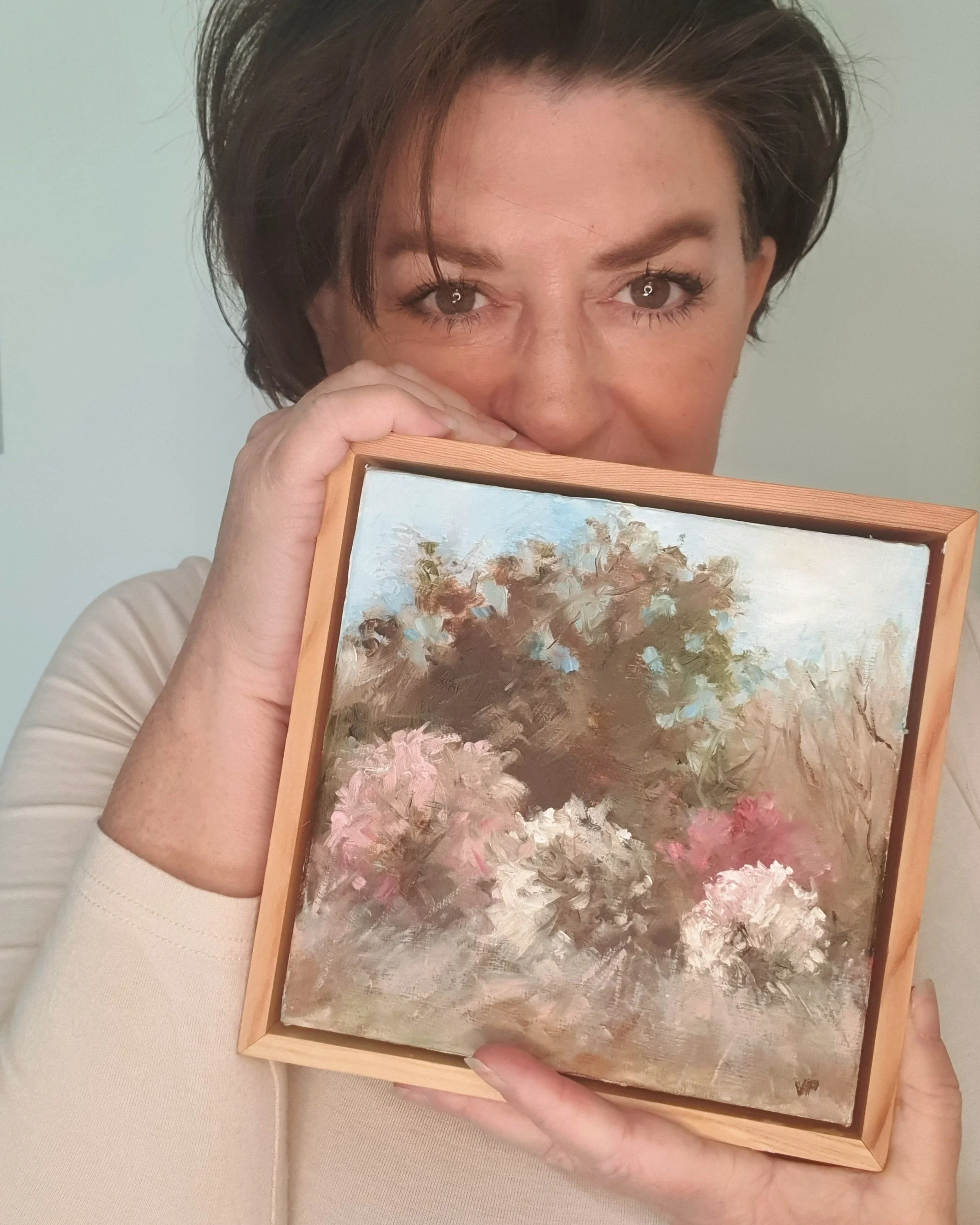 Australian artist Victoria Pynt holding framed mini painting