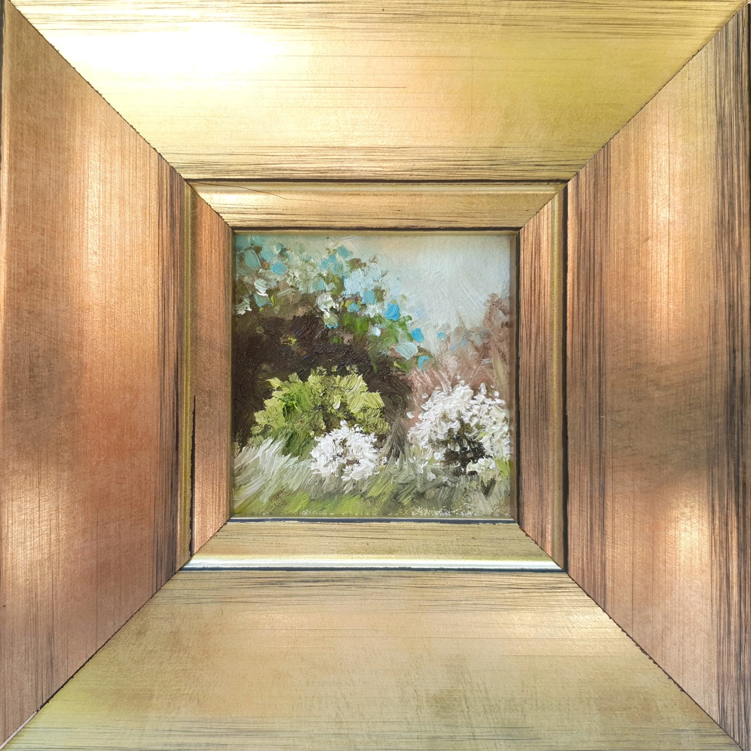 Framed miniature oil painting of rustic country scene with white blossom tree.