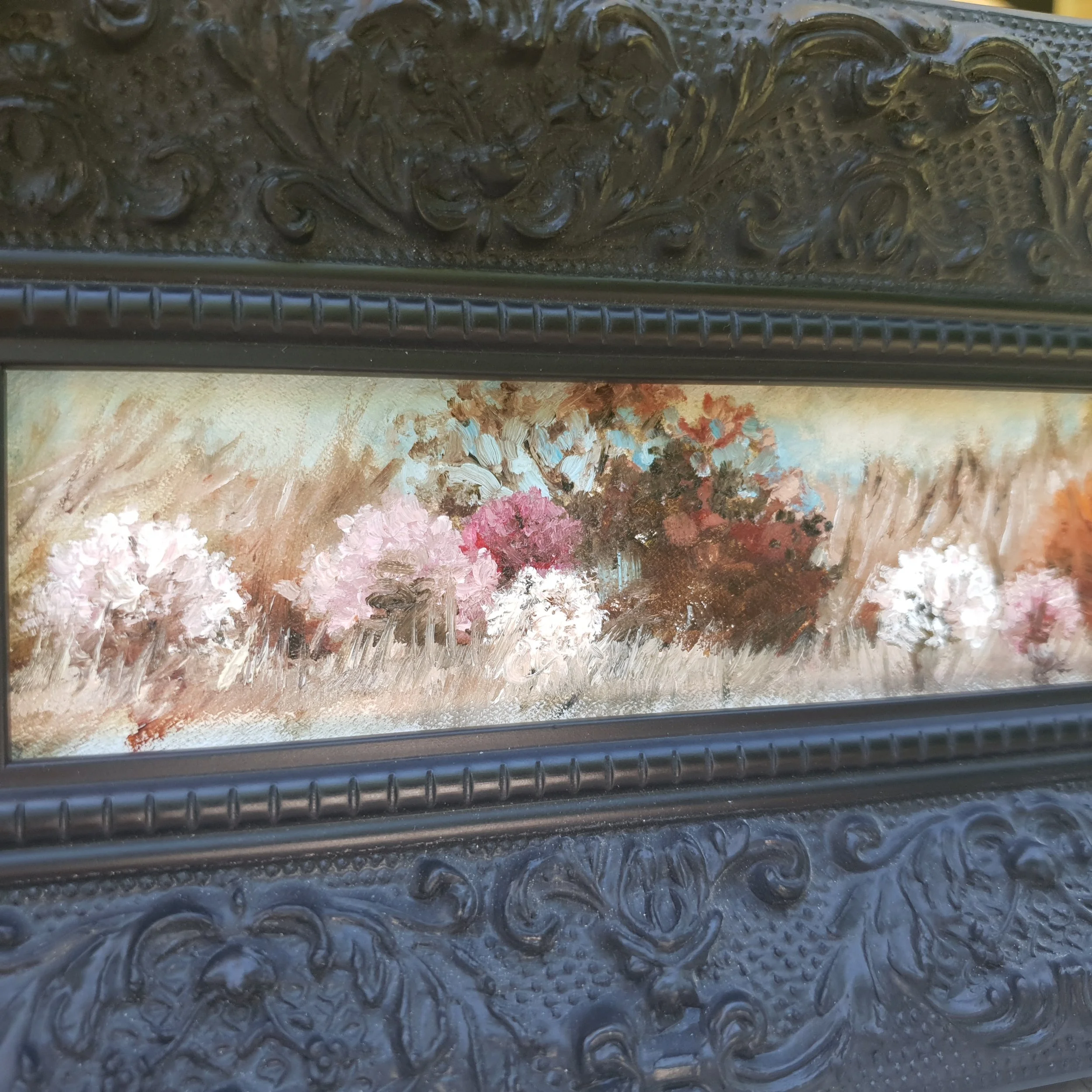 Miniature oil painting in black ornate frame. Soft abstract landscape in natural earth tones of light brown with cherry blossom.
