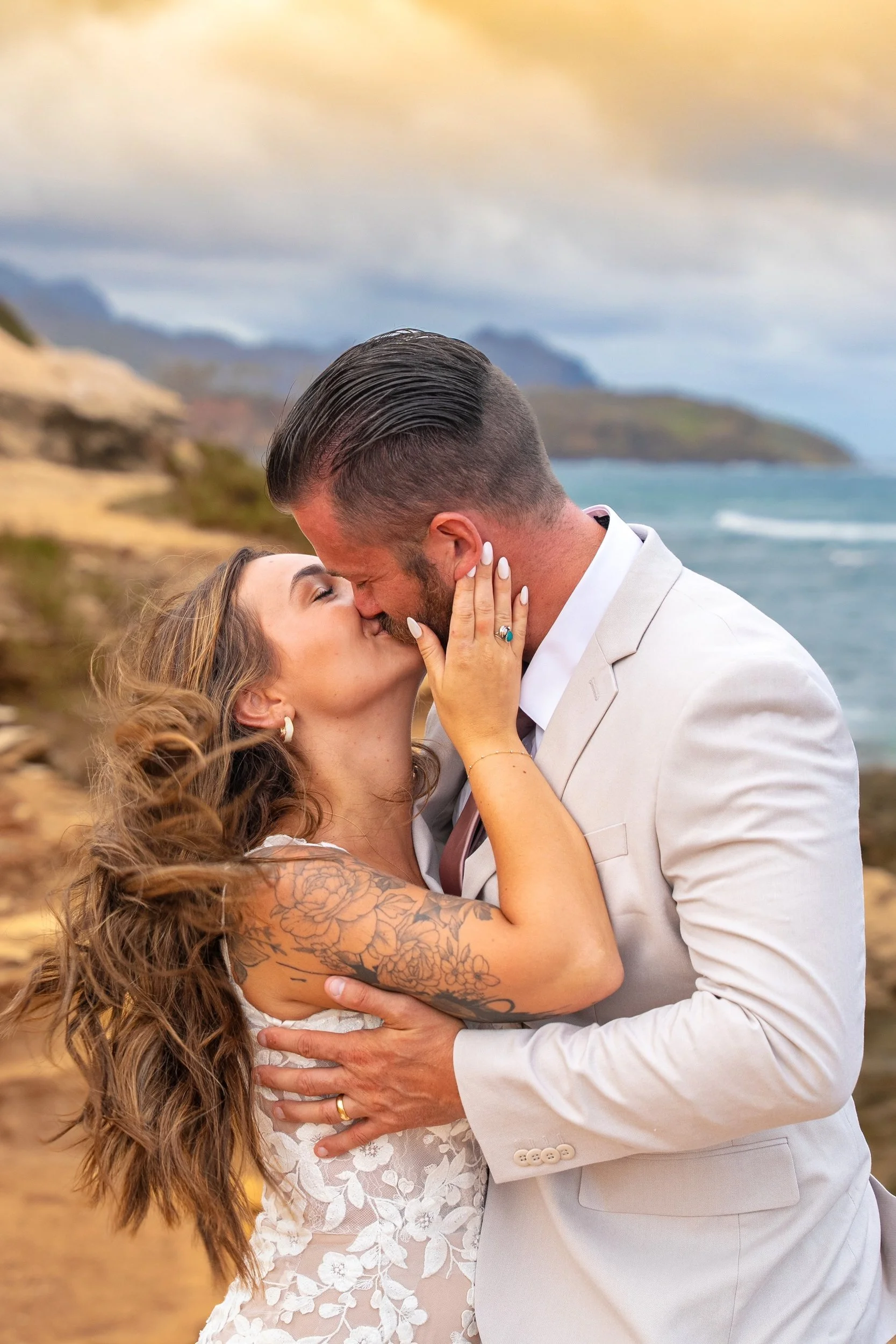 Close-up of a couple kissing at Shipwreck Beach, Kauai.